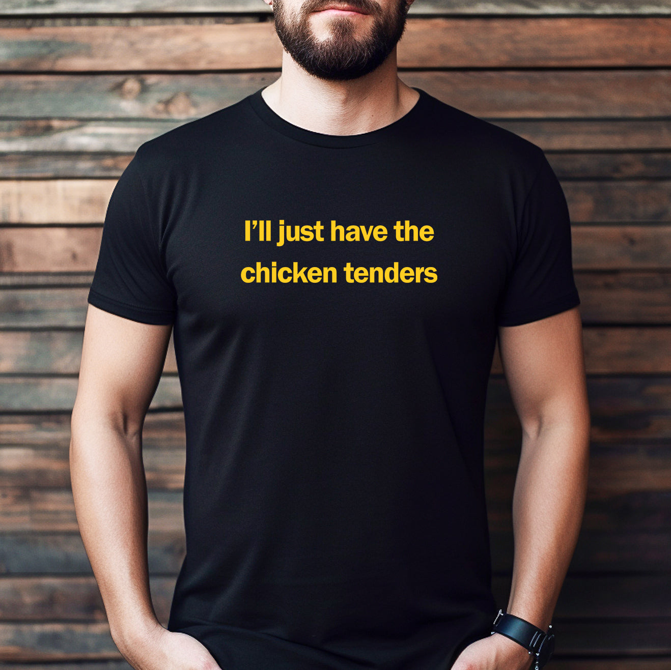 Man wearing a black t-shirt with the phrase I’ll just have the chicken tenders in yellow print