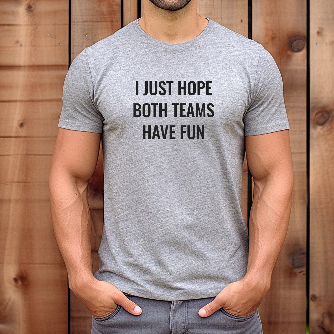 Man wearing heather gray funny sports t-shirt with the phrase "I Just Hope Both Teams Have Fun."