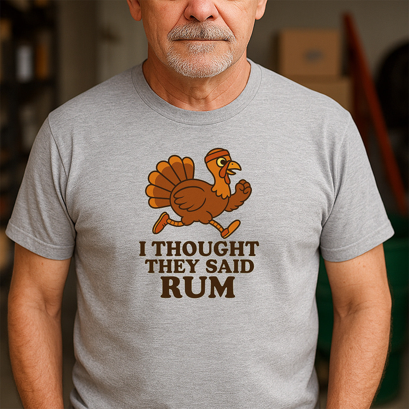 older man wearing gray t-shirt with cartoon turkey running and humorous quote i thought they said rum
