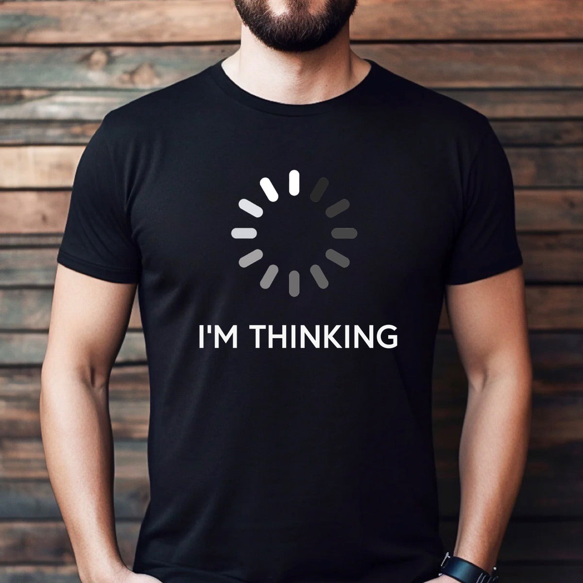 Man wearing black graphic t-shirt with loading circle and text I'm Thinking in white font