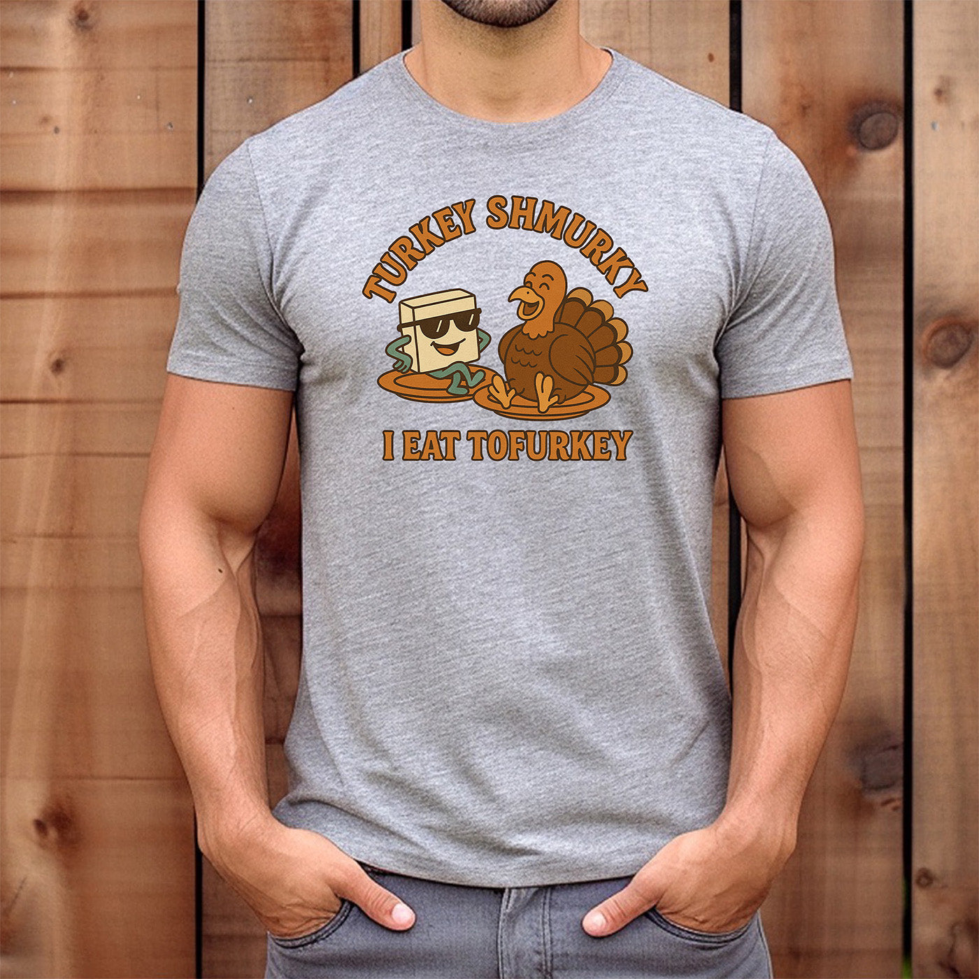 man wearing gray t-shirt with cartoon tofu and turkey and text turkey shmurky i eat tofurkey humorous vegan design