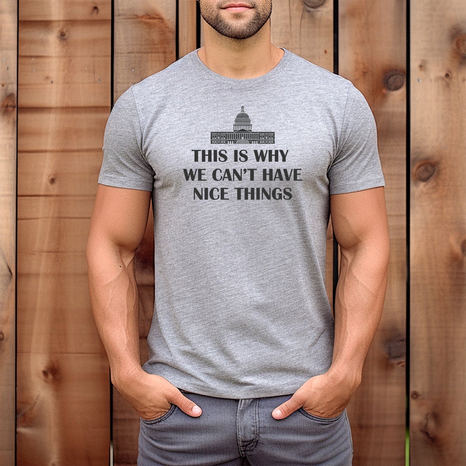 Man wearing a heather grey graphic t-shirt with the U.S. Capitol and text “This is why we can’t have nice things.”