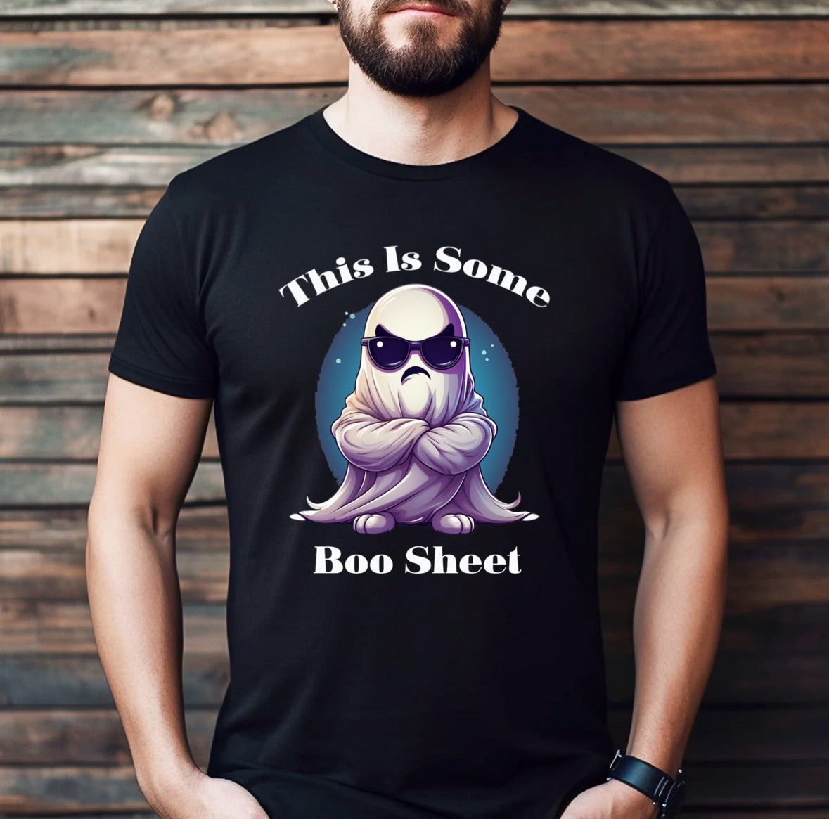 man wearing a black halloween t shirt with ghost graphic and the phrase this is some boo sheet