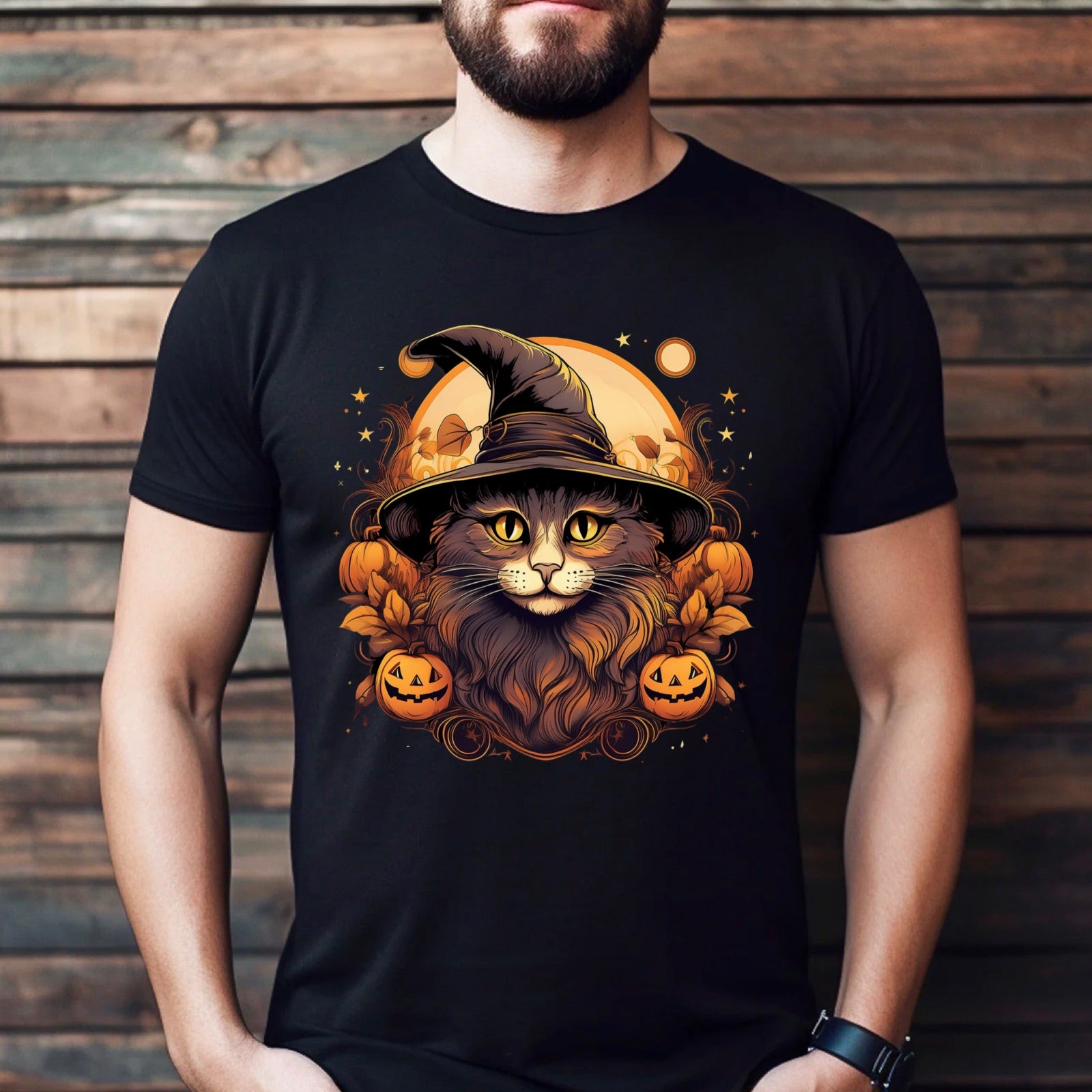 Man wearing a black Halloween t-shirt featuring a cat in witch hat with pumpkins and glowing moon