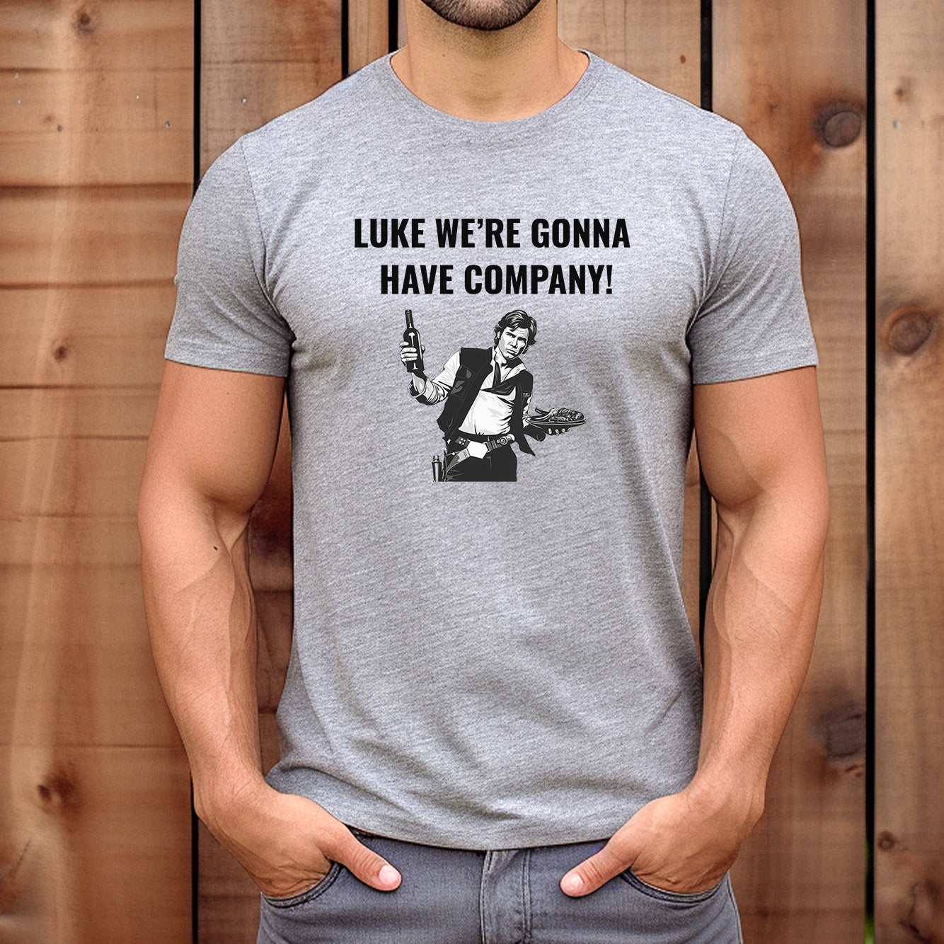 Man wearing grey Star Wars T-shirt with Han Solo holding a bottle and food, text reads “Luke we’re gonna have company!”.