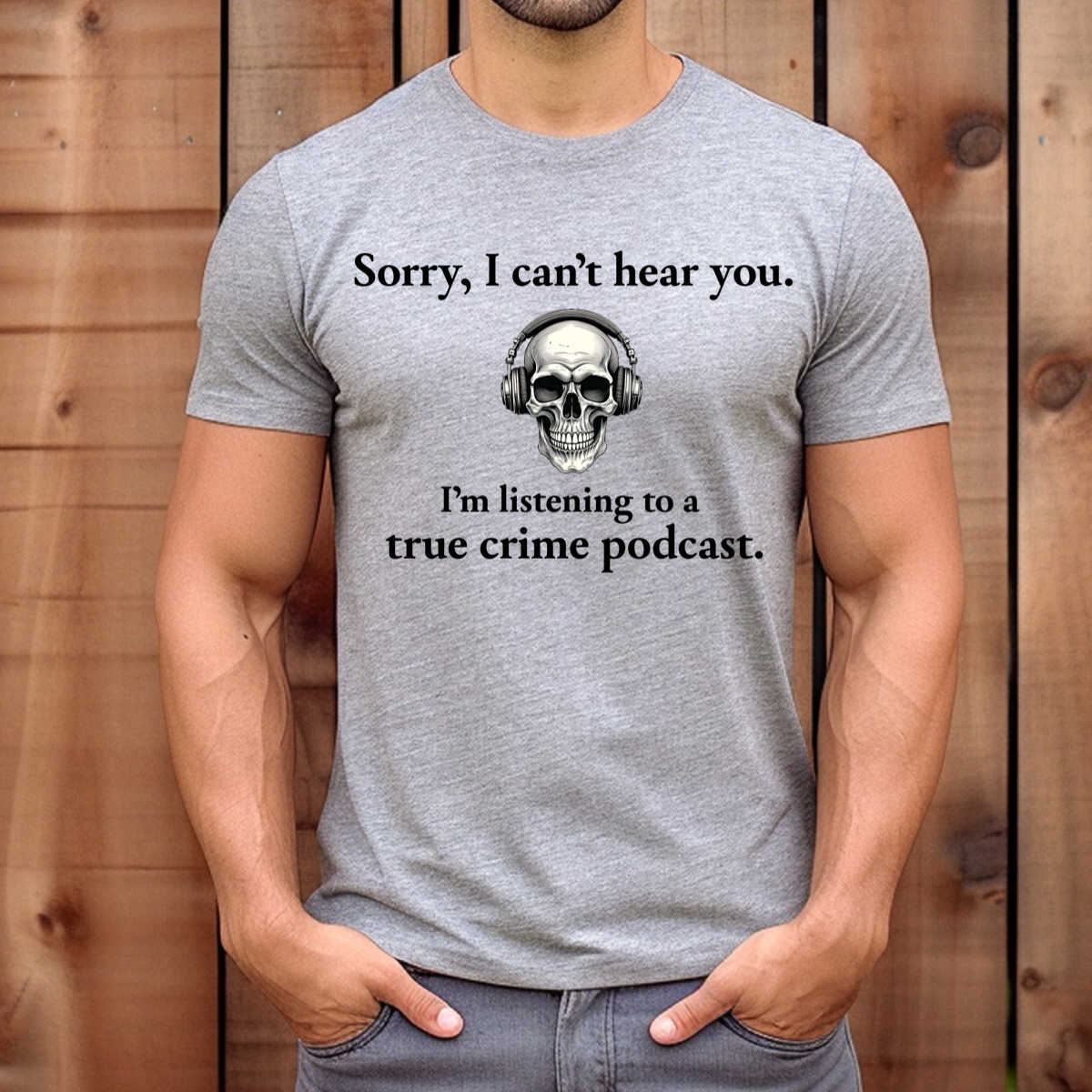 Men’s heather gray t-shirt with skull headphones and true crime podcast quote, wood background mockup