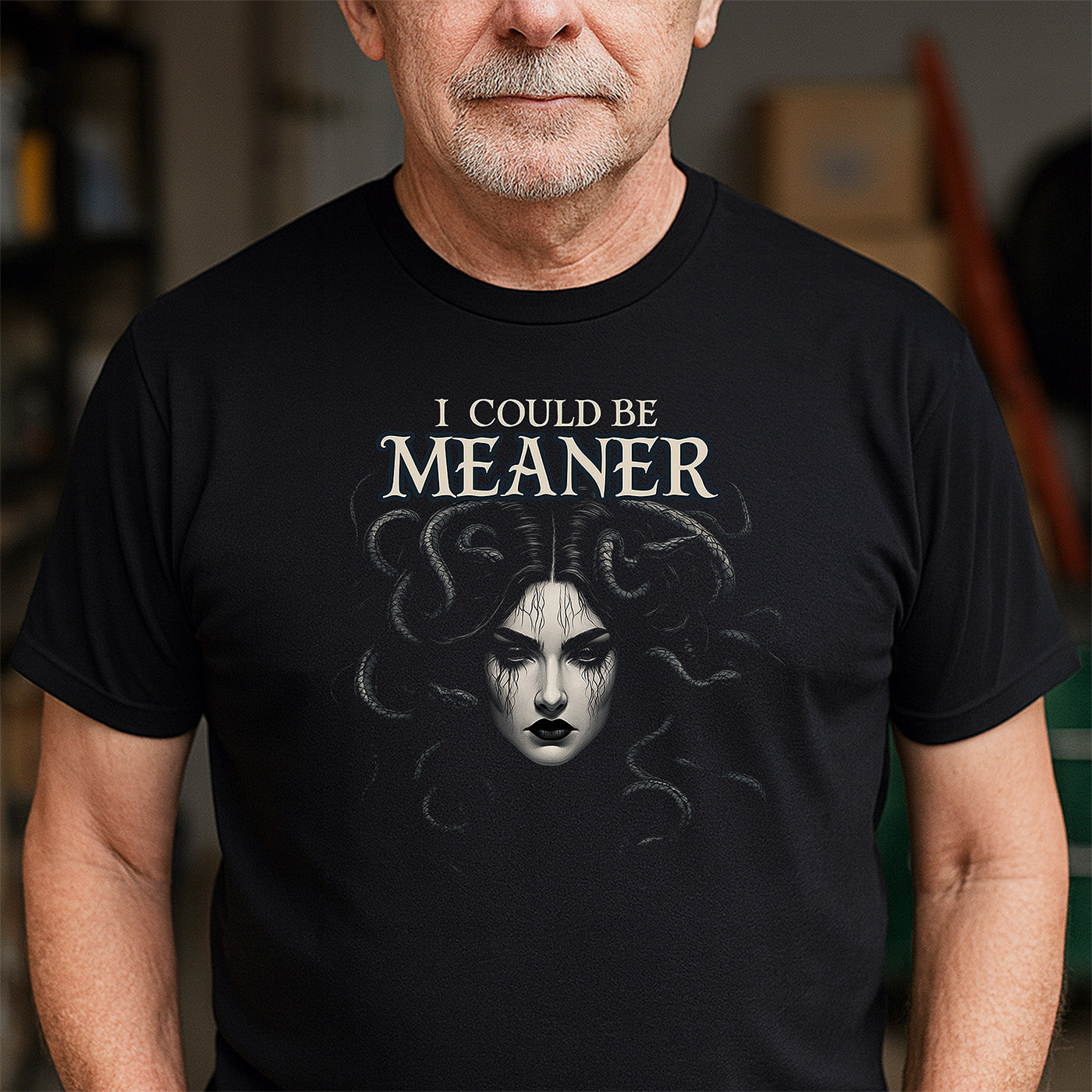 older man wearing black gothic t-shirt with medusa illustration and text i could be meaner