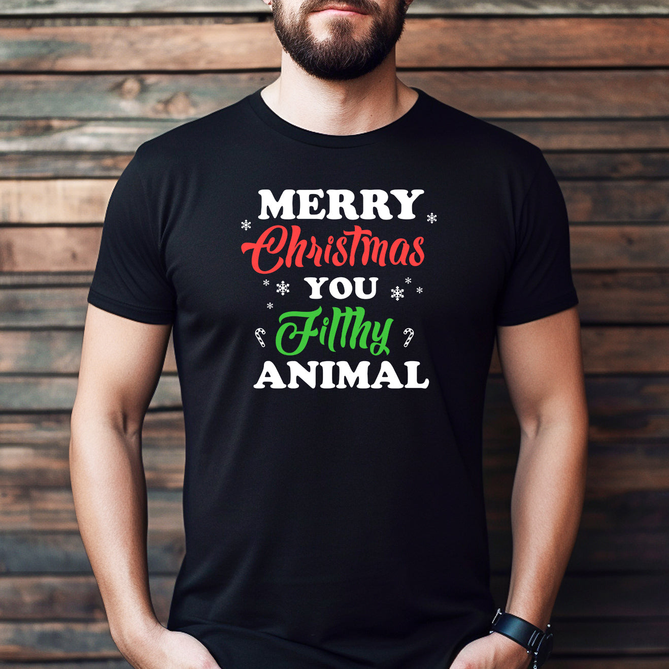 Man wearing black t-shirt with Merry Christmas You Filthy Animal festive holiday design