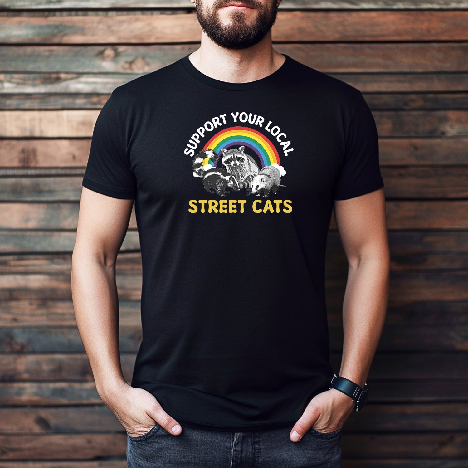 Men’s black graphic tee with rainbow and raccoons saying Support Your Local Street Cats