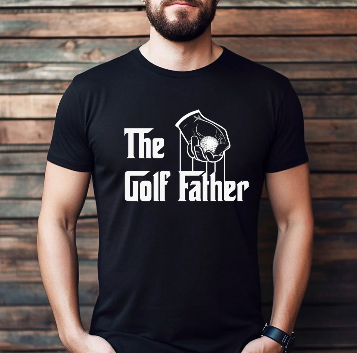 Man wearing The Golf Father black t-shirt with golf ball hand design, humorous golf apparel