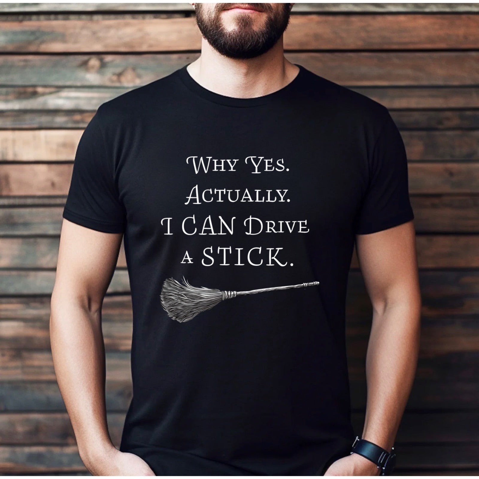 Man in black t-shirt with broomstick design and wording Why Yes Actually I Can Drive a Stick