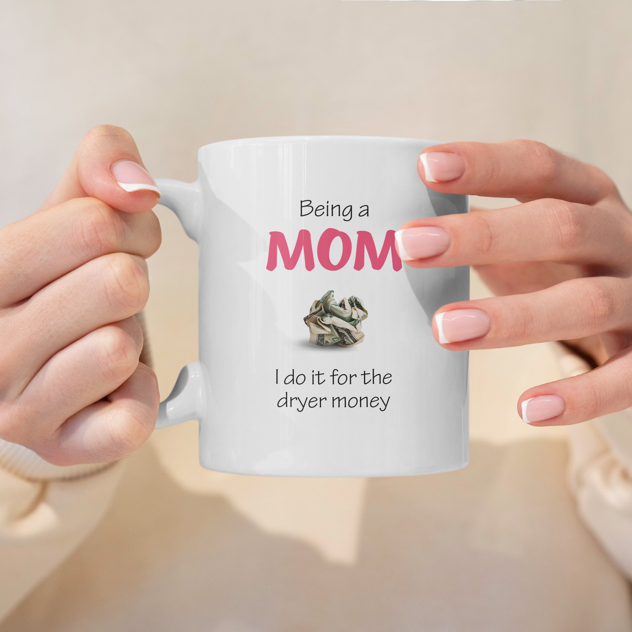 White ceramic mom mug held in hands with saying being a mom I do it for the money, perfect gift for moms