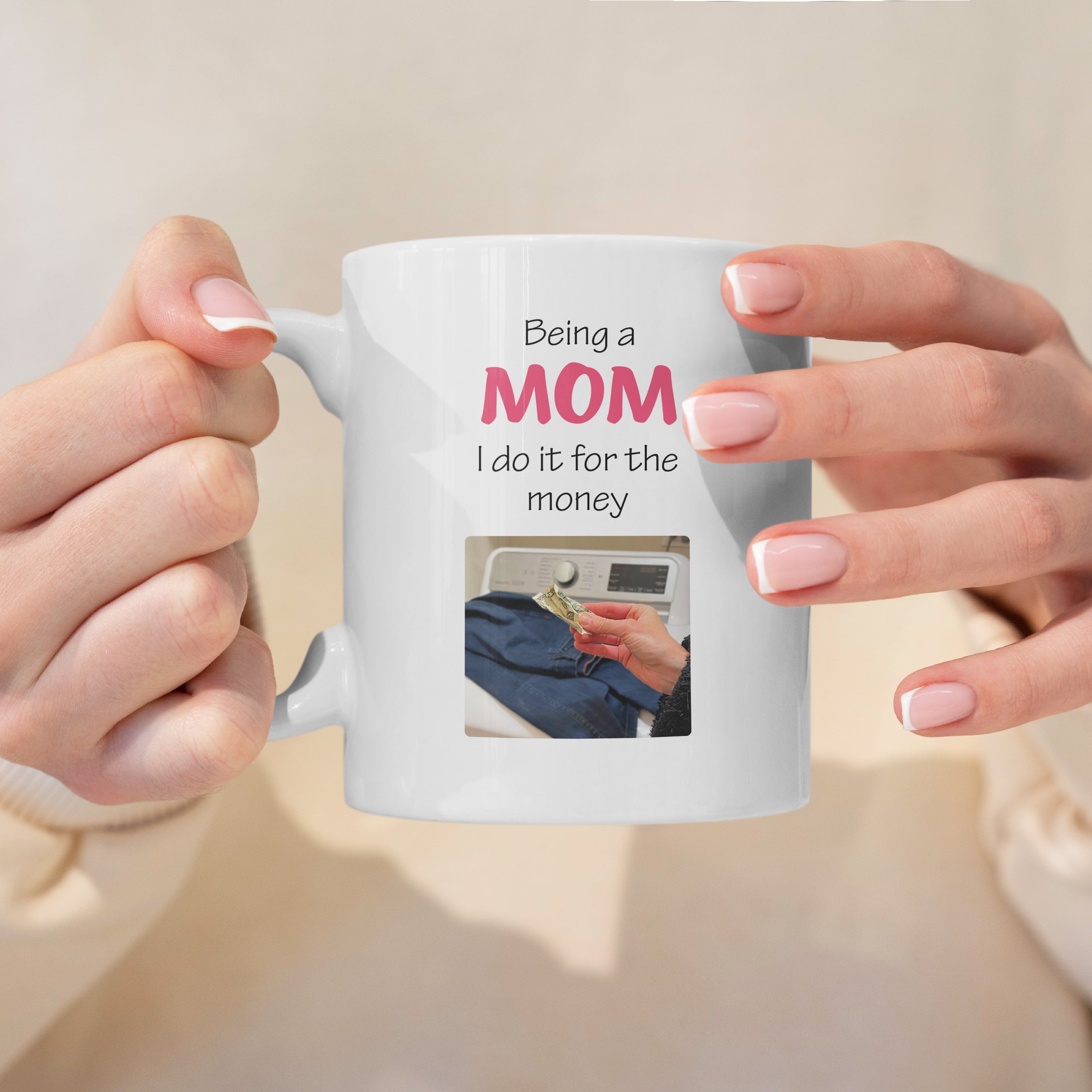 White ceramic mom mug held in hands with saying being a mom I do it for the money, perfect gift for moms