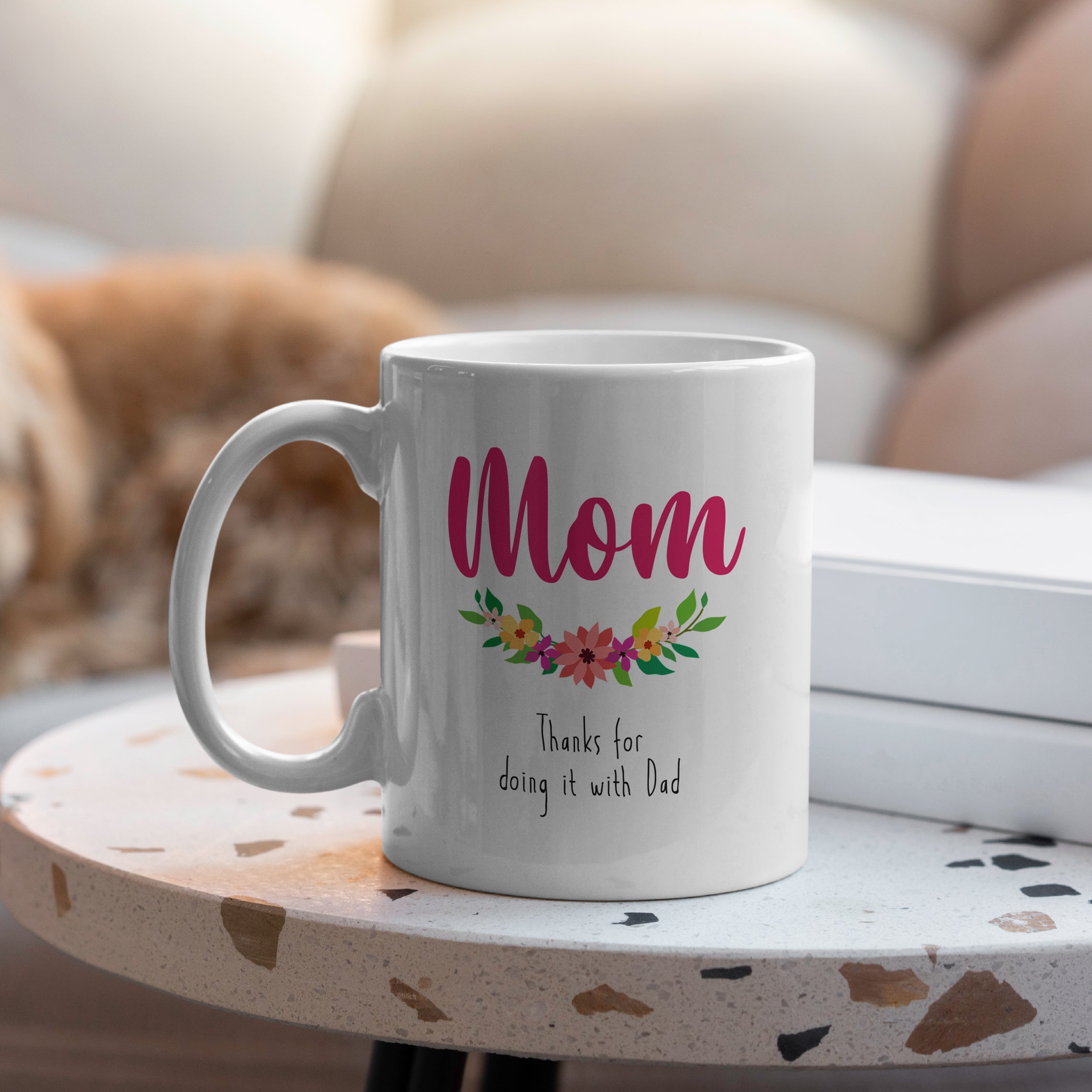 White ceramic coffee mug with floral design and text Thanks for Doing It with Dad on table
