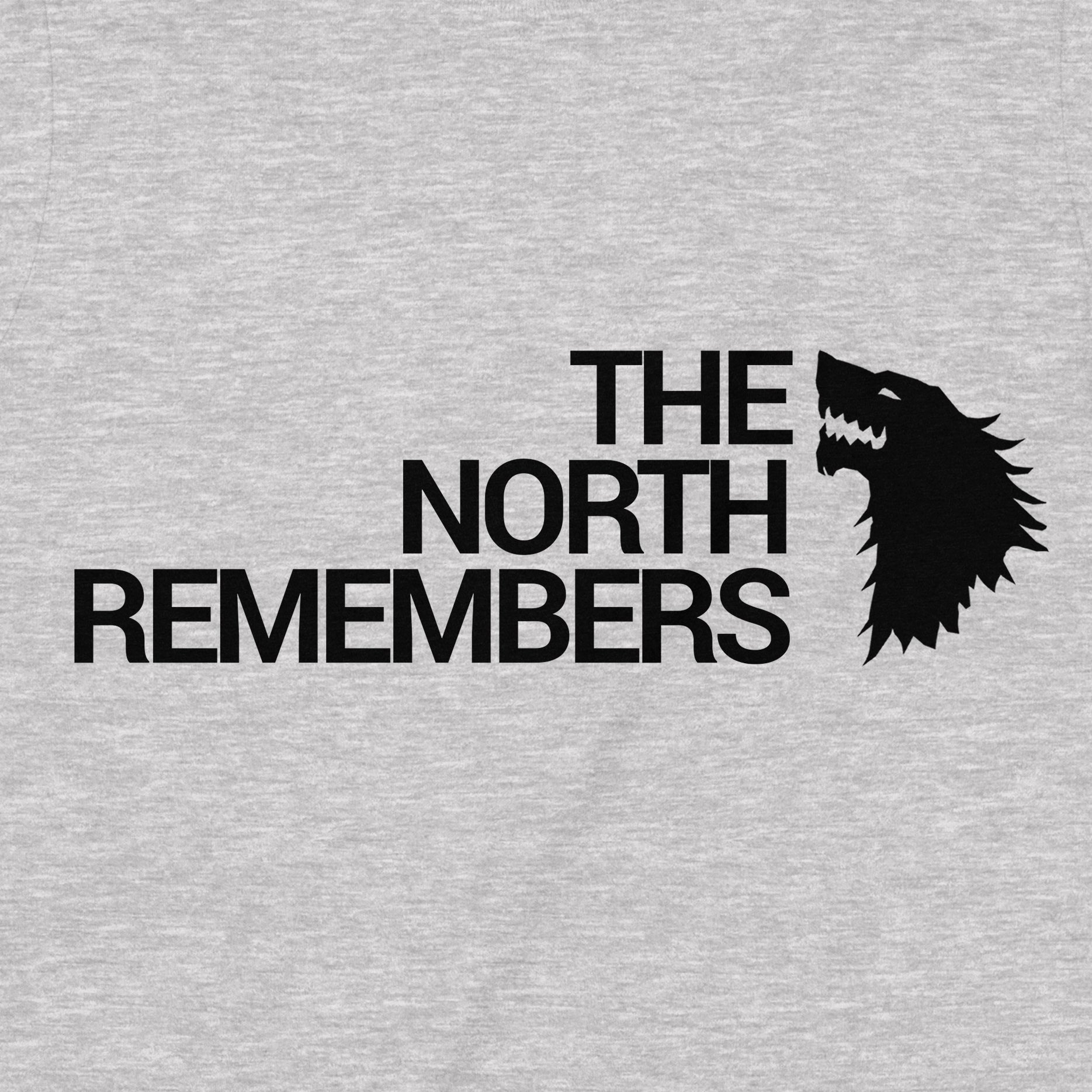 Close-up of black direwolf silhouette and 'The North Remembers' design on grey Game of Thrones t-shirt