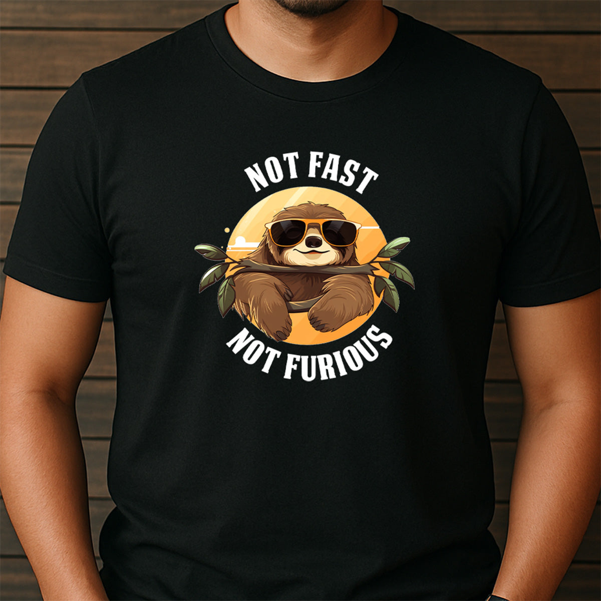 Man wearing black crew neck t-shirt with funny sloth design and slogan not fast not furious