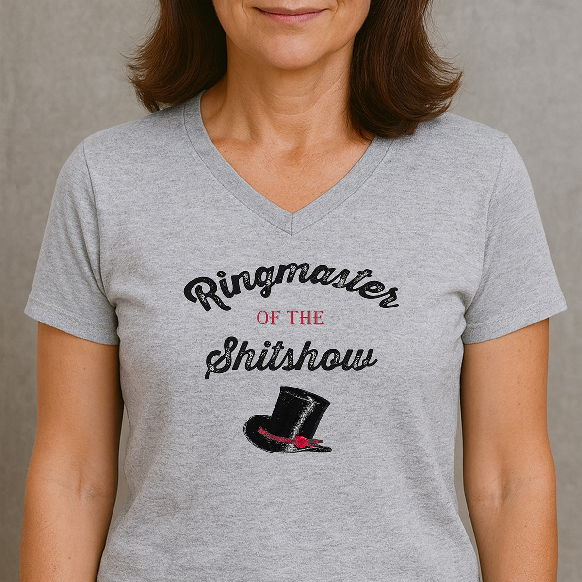 Women’s V-neck heather gray Ringmaster of the Shitshow T-shirt with vintage top hat graphic, studio portrait