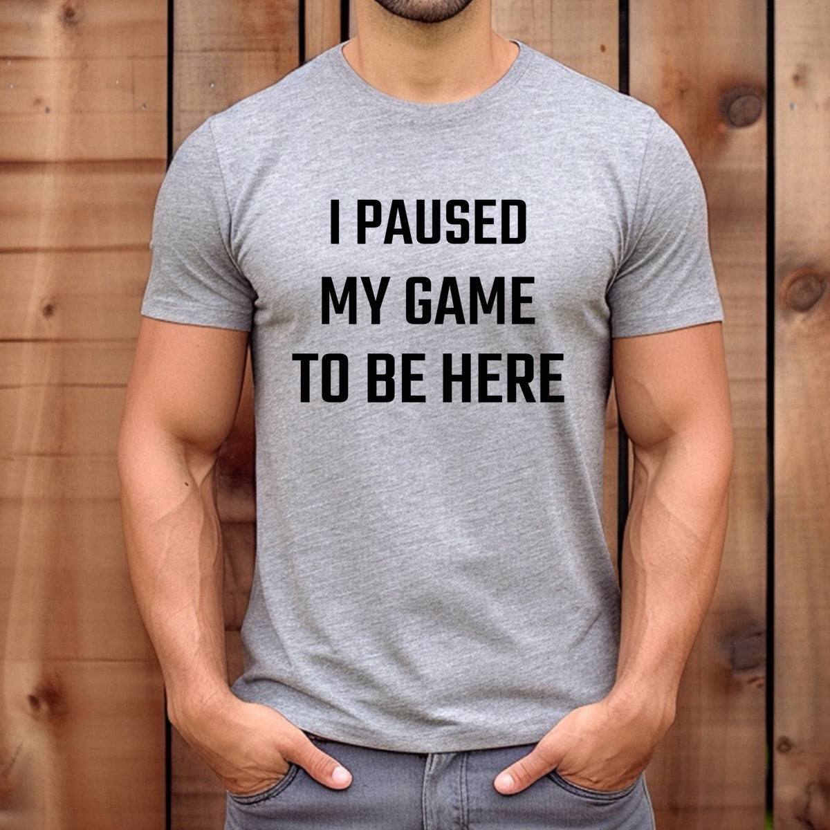 Man wearing grey gamer t-shirt with black text I Paused My Game To Be Here, casual funny gaming tee