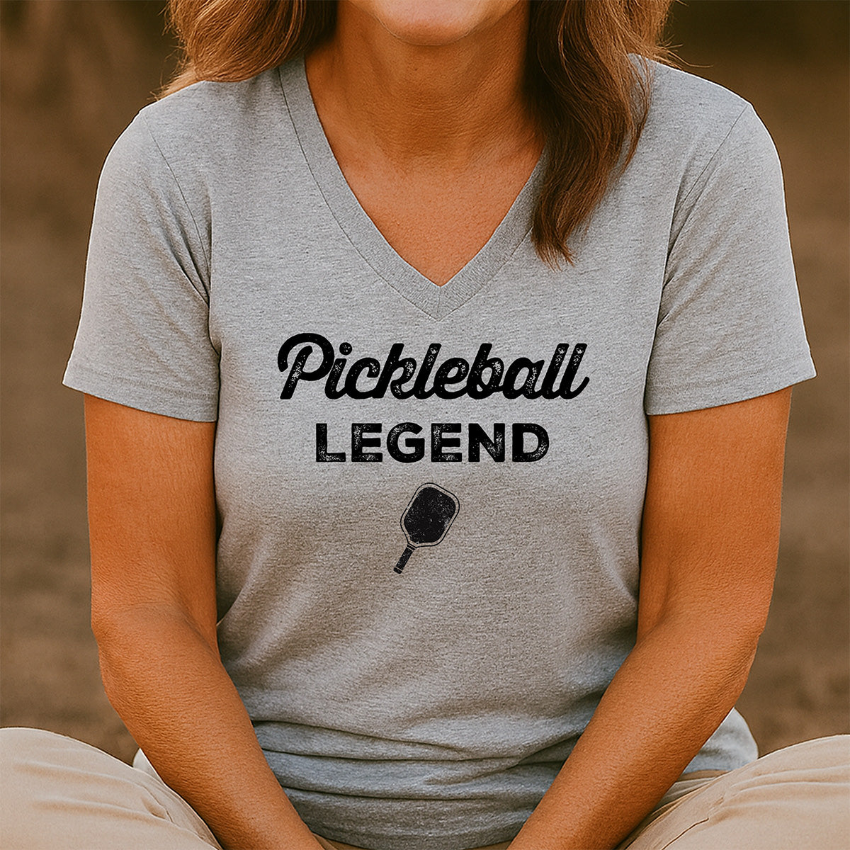 Women’s v-neck gray Pickleball Legend shirt with paddle design and black print, lightweight casual wear for sports fans