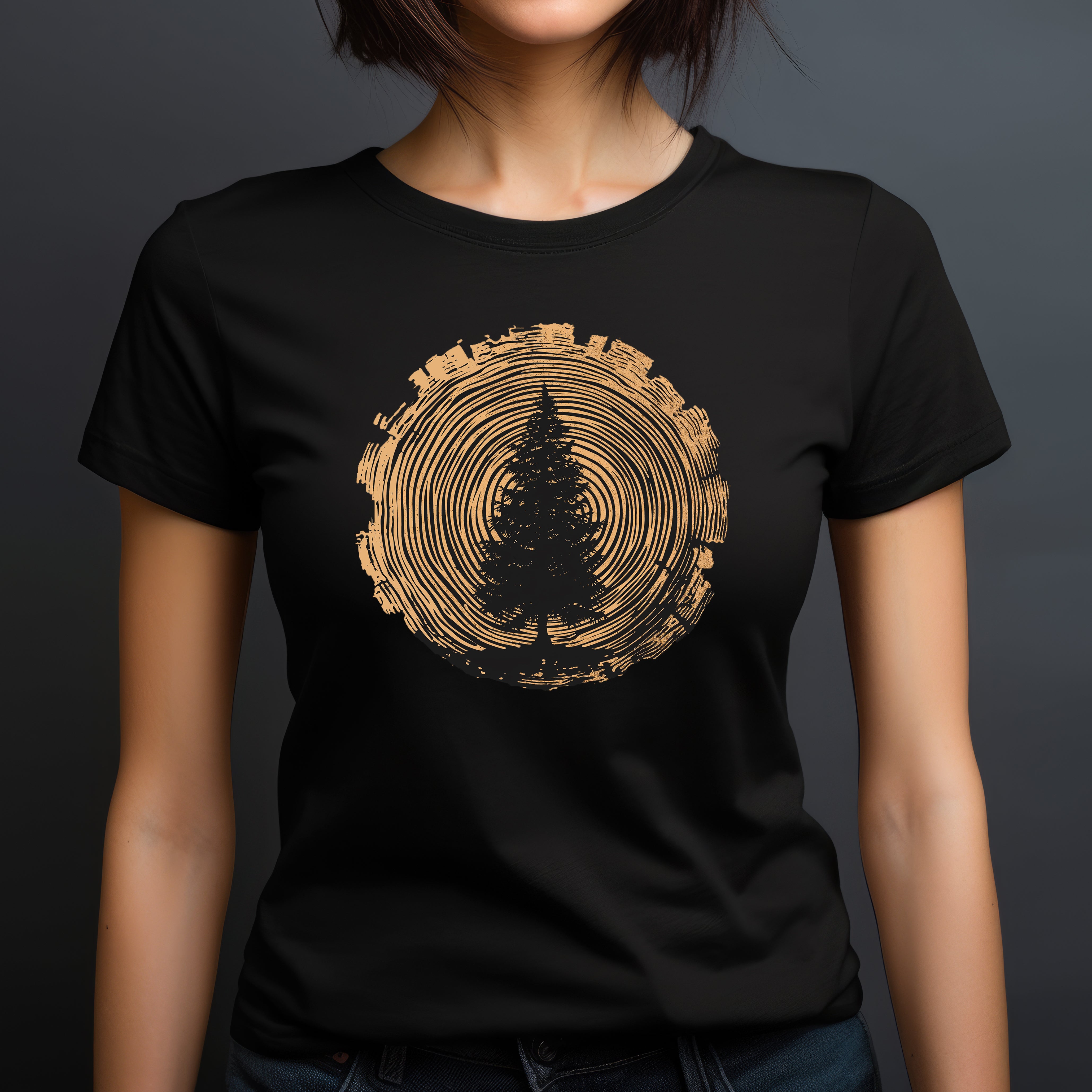 Women’s crew-neck black tee with pine tree silhouette framed by golden log cross-section rings.