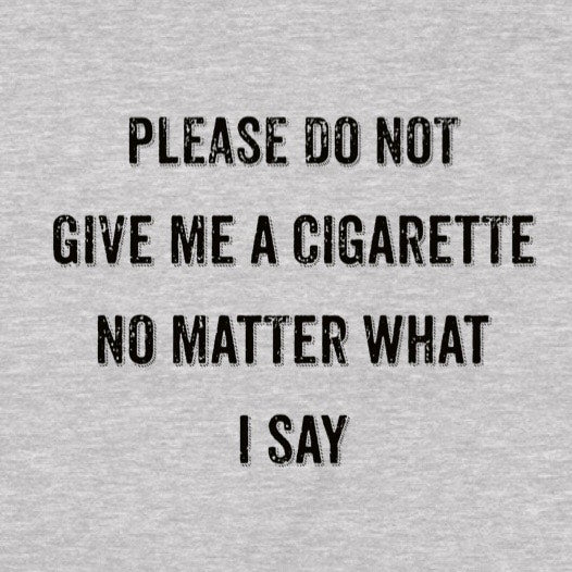 Closeup of text Please do not give me a cigarette on heather gray anti-smoking t-shirt, distressed black lettering