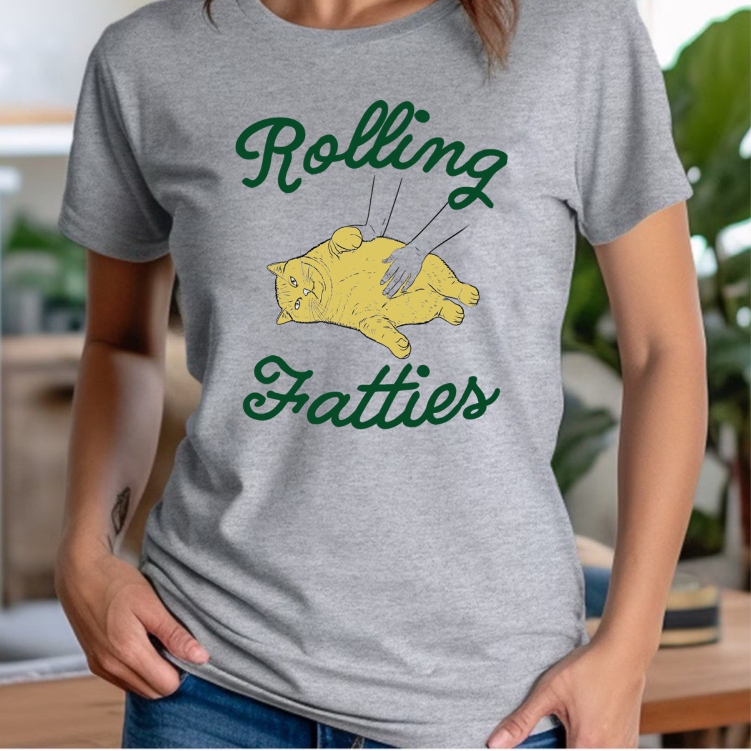 Woman in gray crewneck Rolling Fatties shirt with yellow cat cartoon design