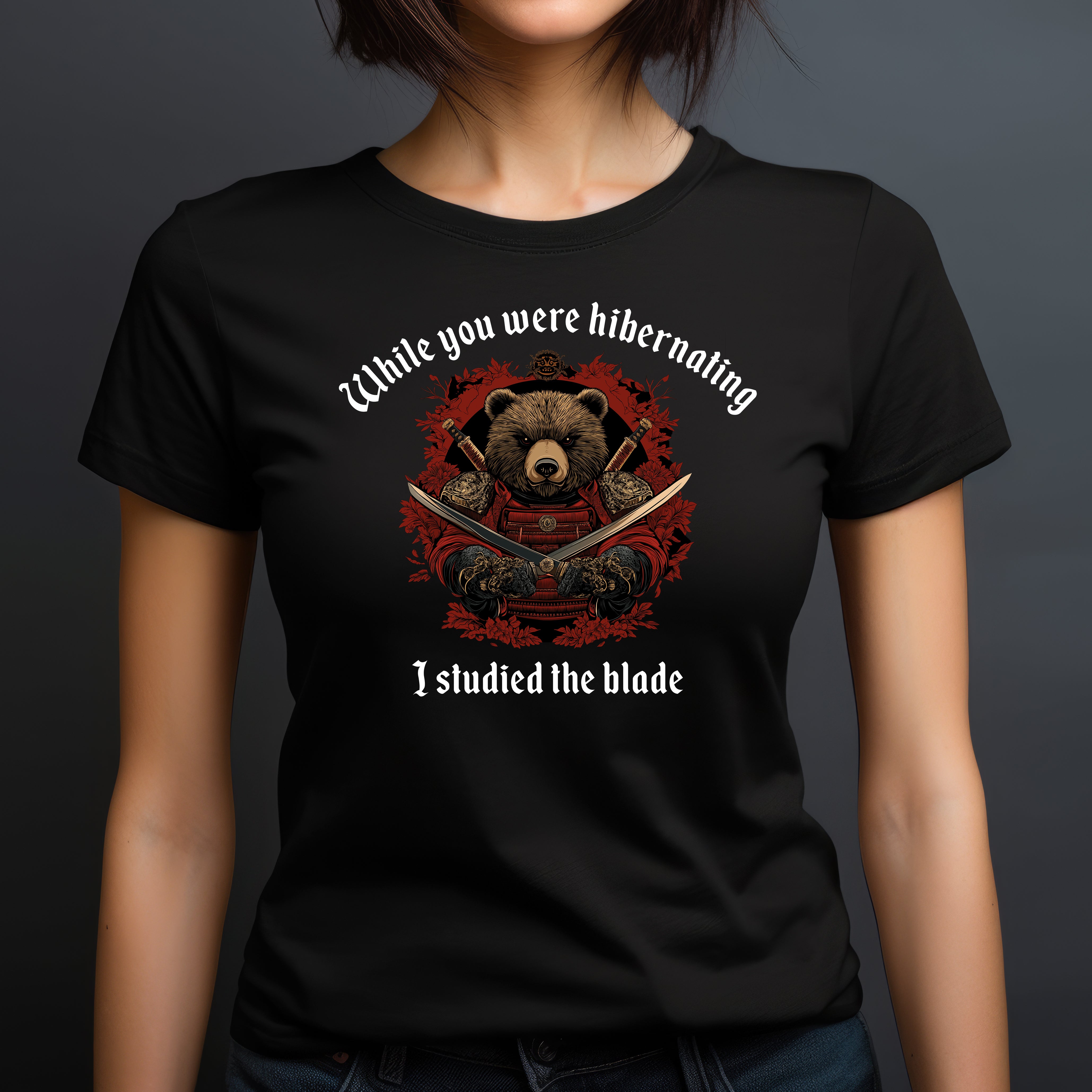 Woman in black crew neck t-shirt with samurai bear graphic and humorous quote While you were hibernating I studied the blade