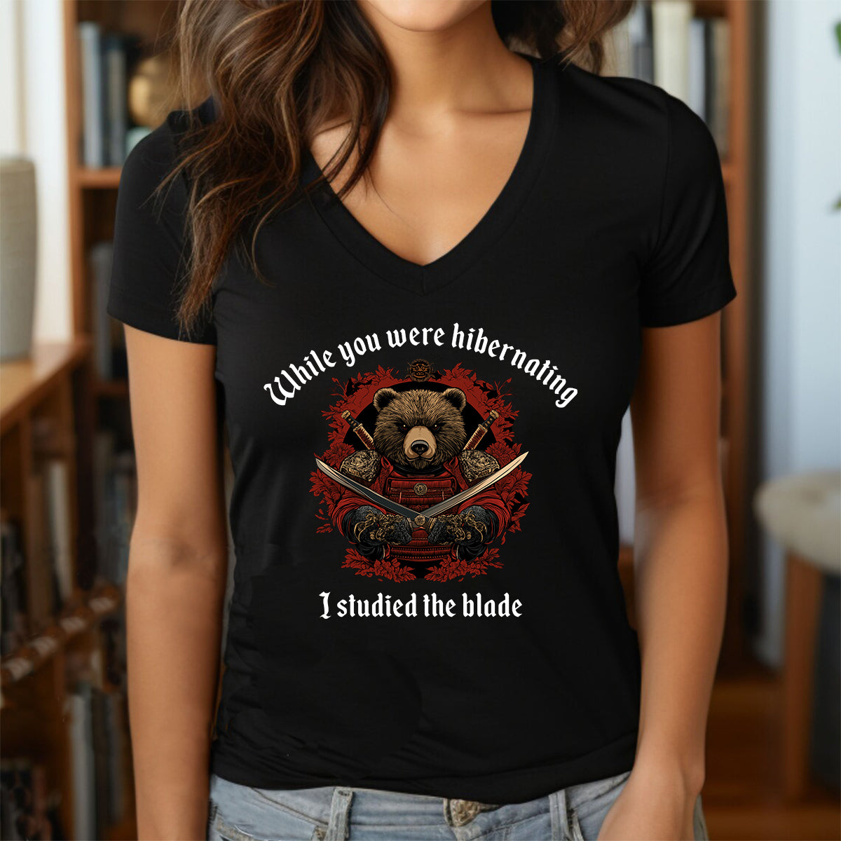 Woman wearing black v-neck t-shirt with samurai bear artwork and quote While you were hibernating I studied the blade