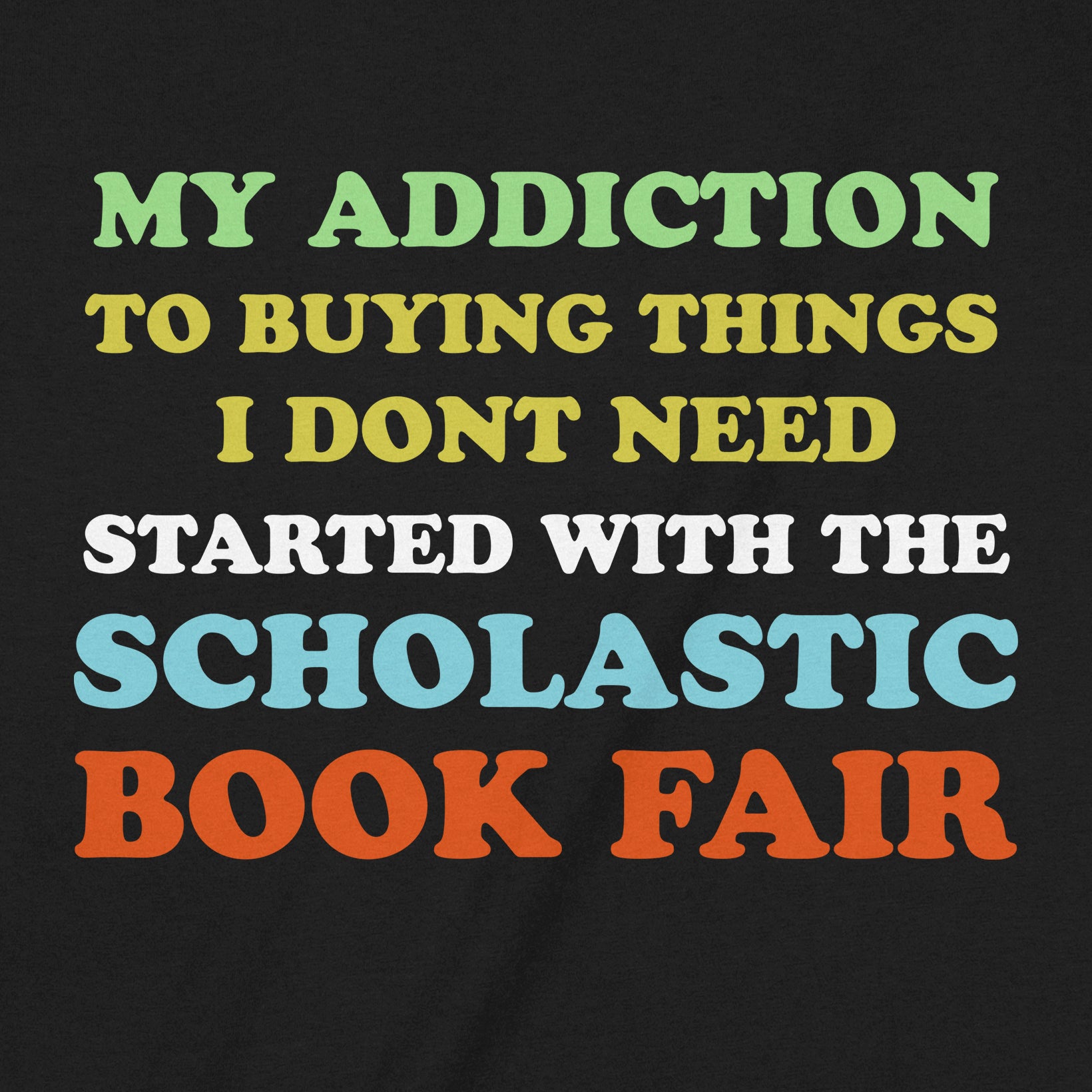Close-up of the graphic design on a black shirt showing bold, multicolor text about the Scholastic Book Fair.