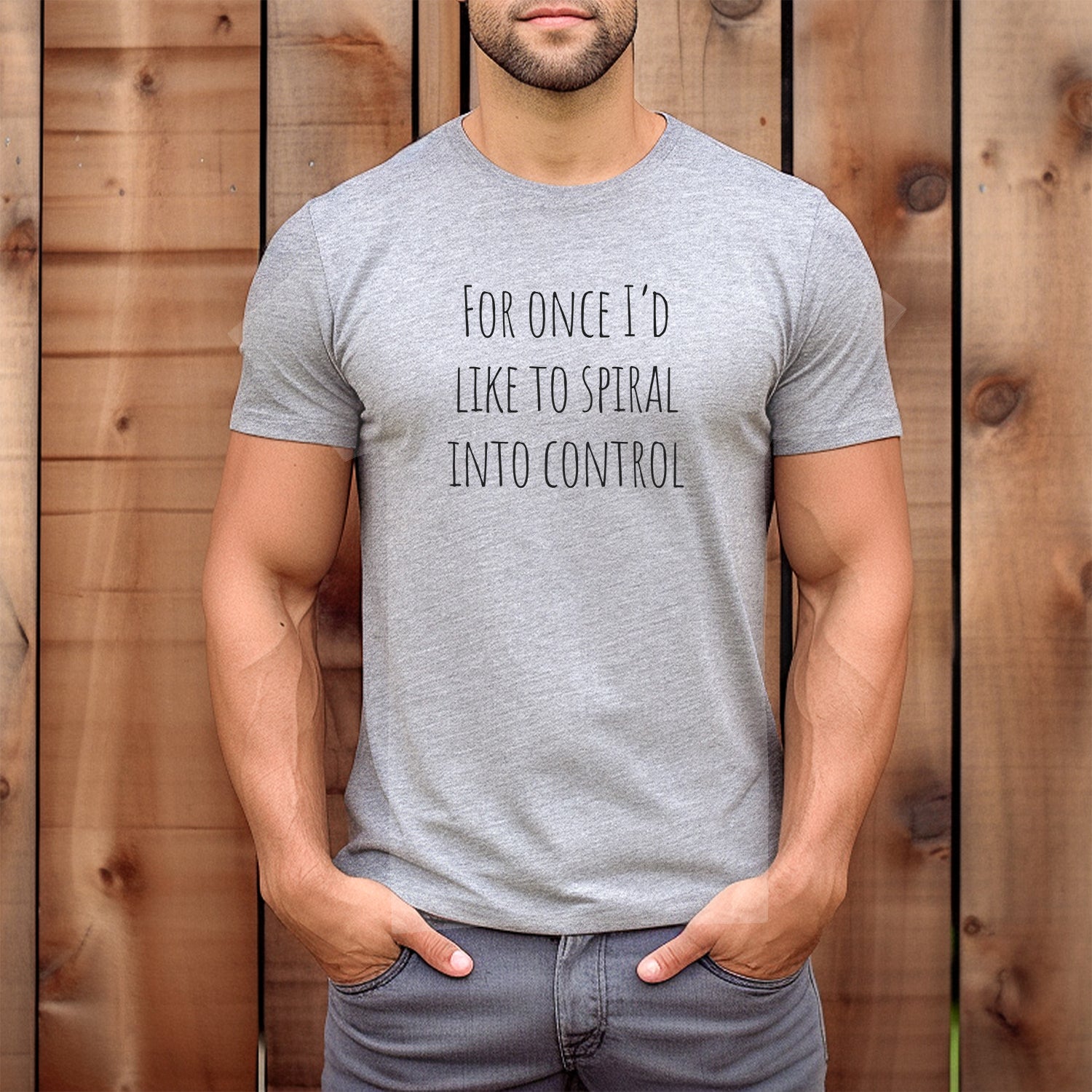Man wearing heather gray tee that says For once I'd like to spiral into control; casual sarcastic graphic shirt