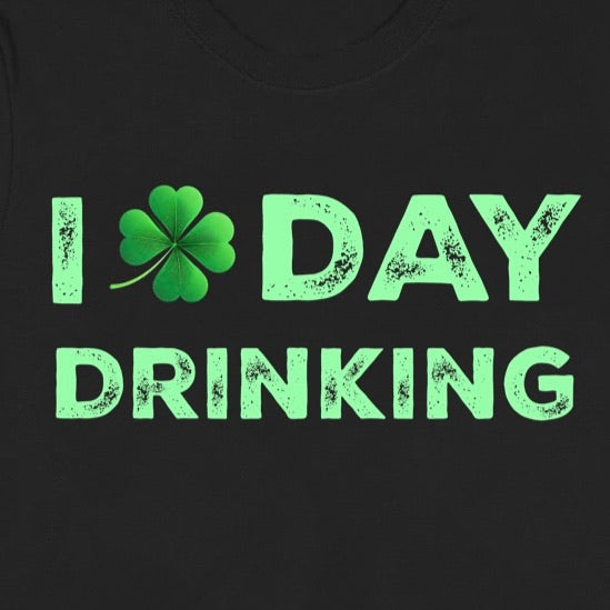 Closeup of black t-shirt with green shamrock and bold distressed text I Day Drinking