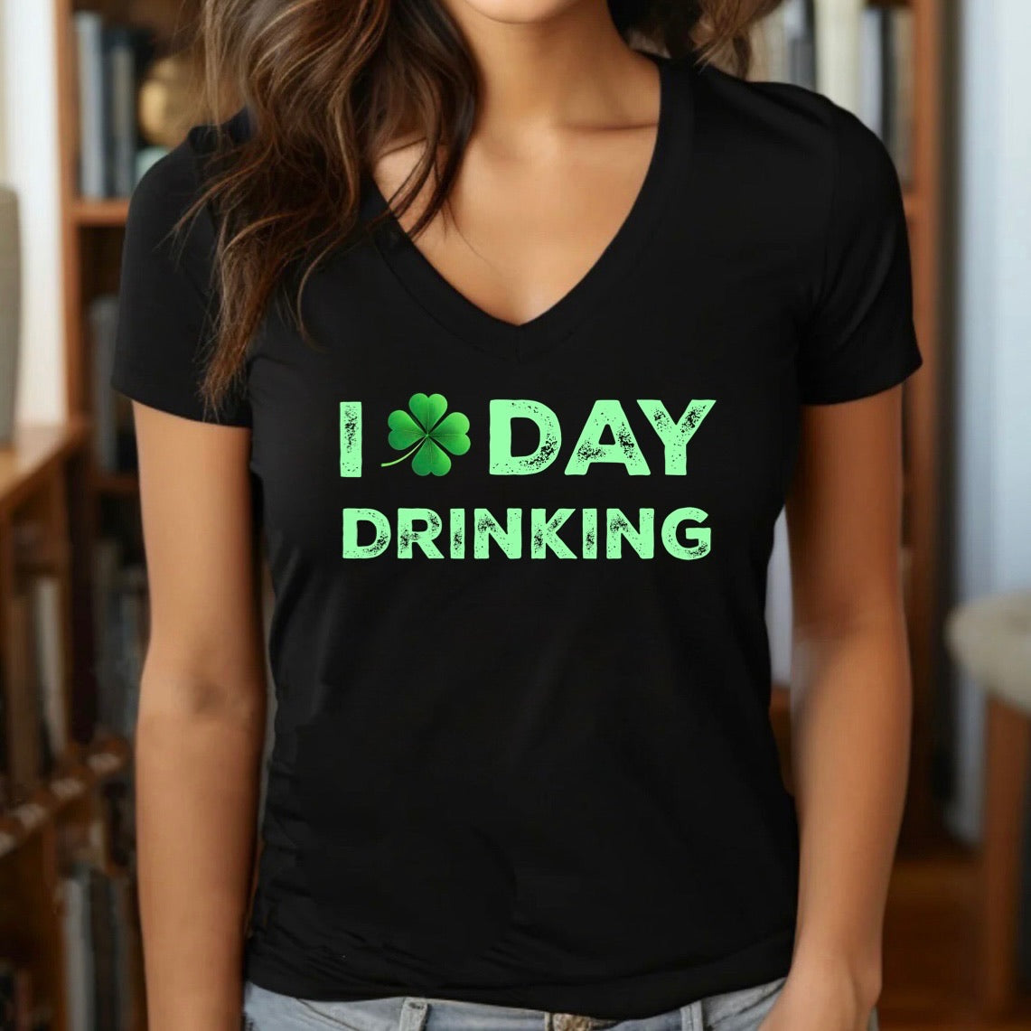 Woman in black v-neck t-shirt with green shamrock and bold I Day Drinking St. Patrick's Day design