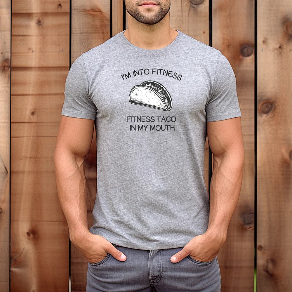Man wearing gray taco fitness t-shirt with fitness taco in my mouth slogan and taco illustration
