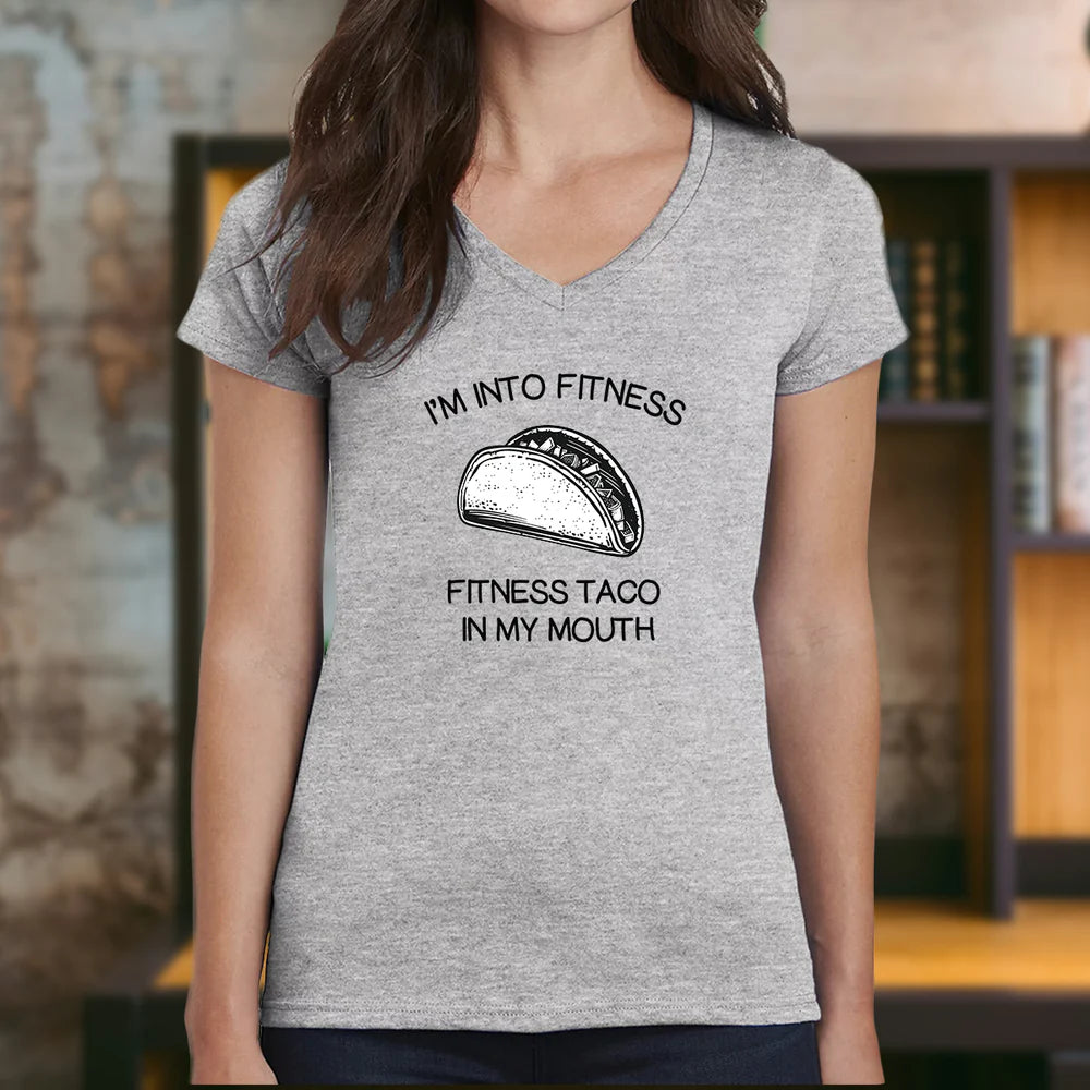 Woman in gray v-neck taco fitness shirt with illustrated taco and fitness taco in my mouth text