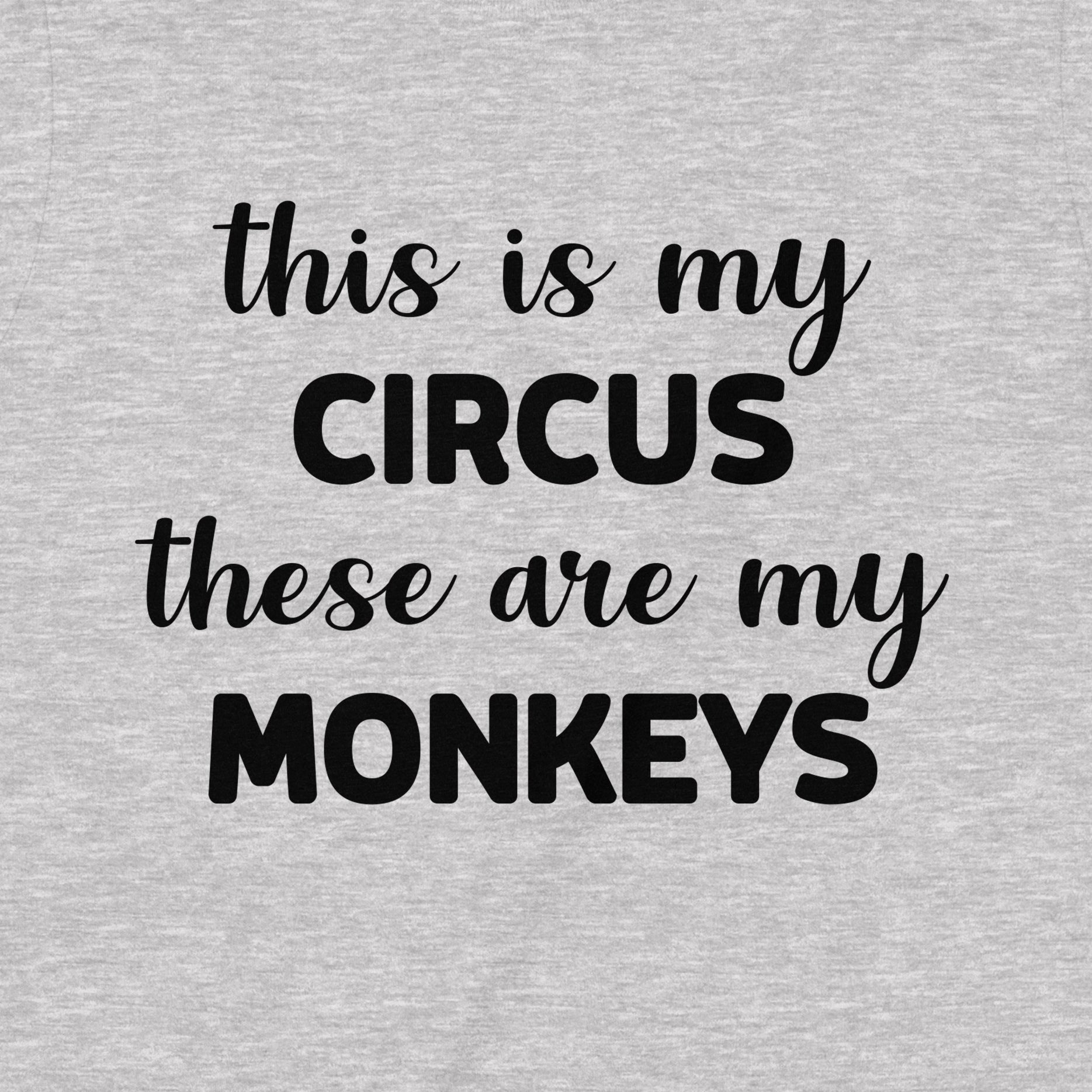 Closeup of grey t-shirt with humorous quote This Is My Circus These Are My Monkeys printed in black lettering