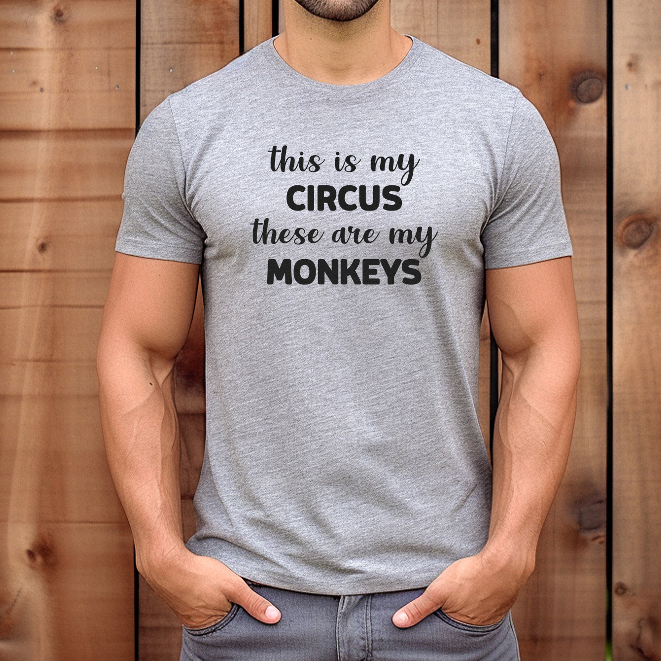 Man wearing grey t-shirt with the funny phrase This Is My Circus These Are My Monkeys in bold text