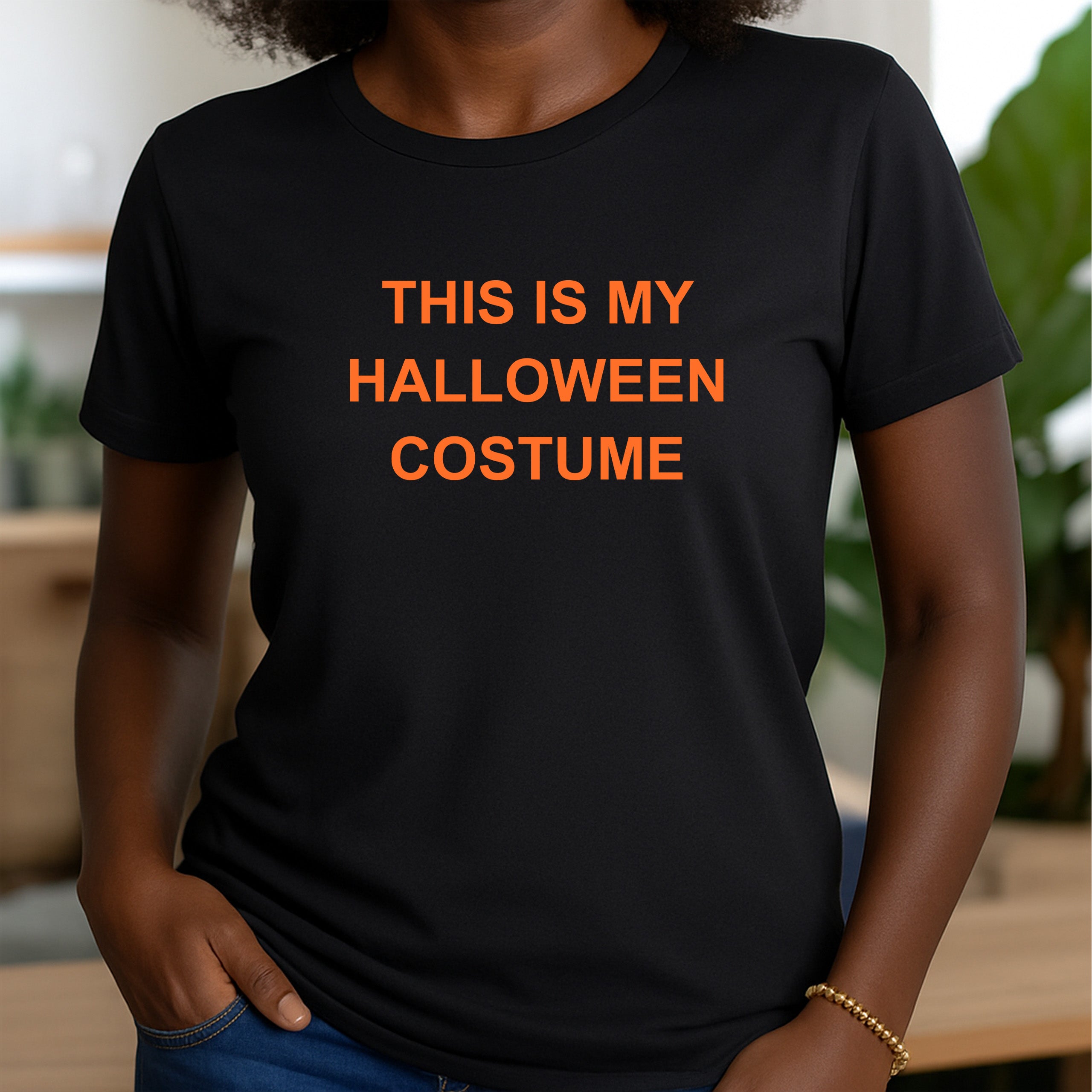 Woman in black crew neck t-shirt featuring bold orange lettering this is my halloween costume