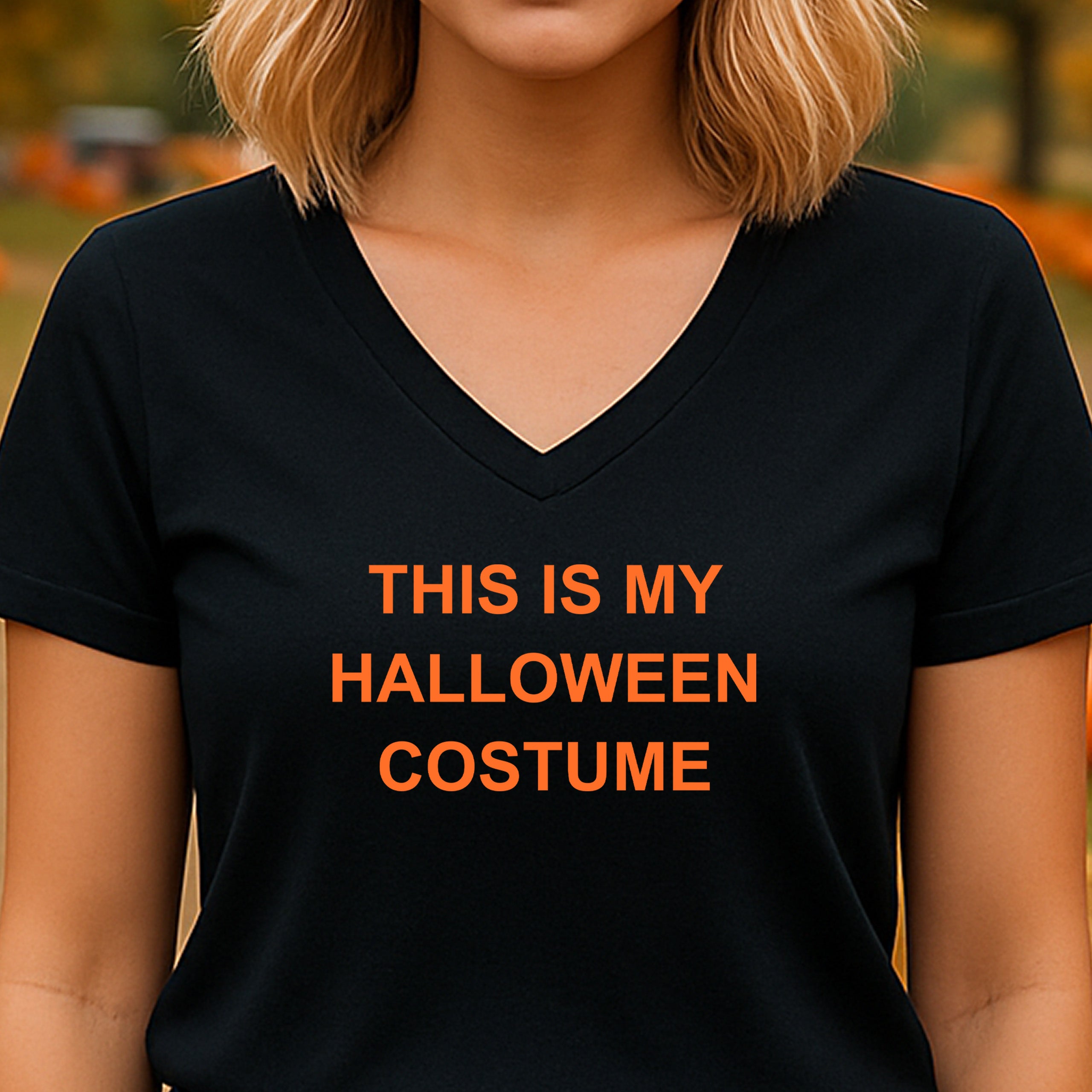 Woman wearing black v-neck shirt with orange halloween slogan this is my halloween costume