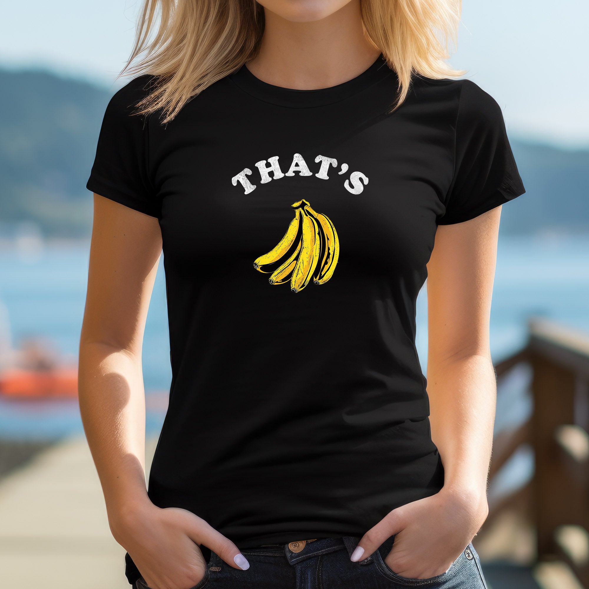 Woman outdoors wearing stylish black "That's Bananas" graphic t-shirt with banana design and playful slogan.