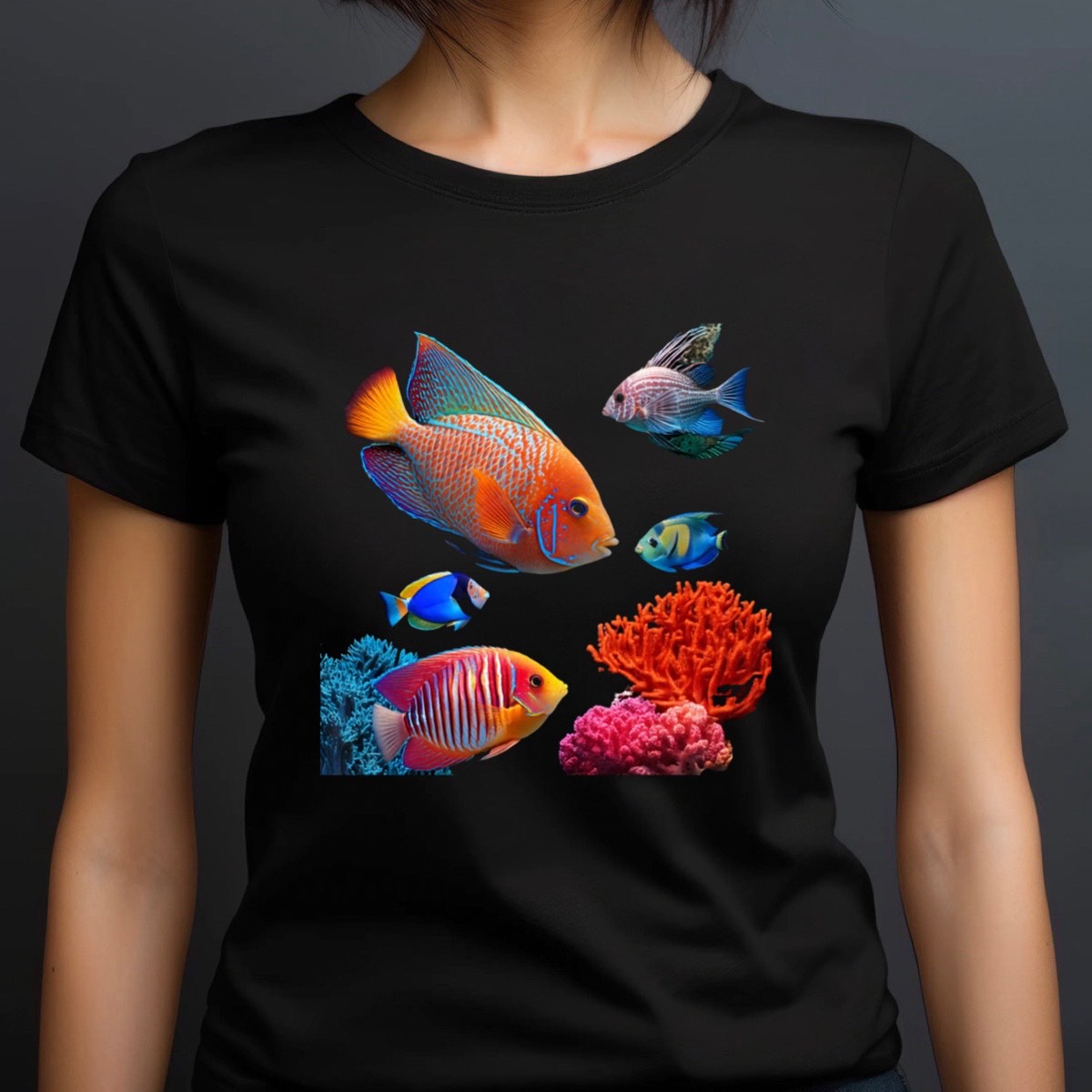 Woman wearing black crewneck t-shirt featuring vibrant tropical reef fish and coral artwork, studio portrait