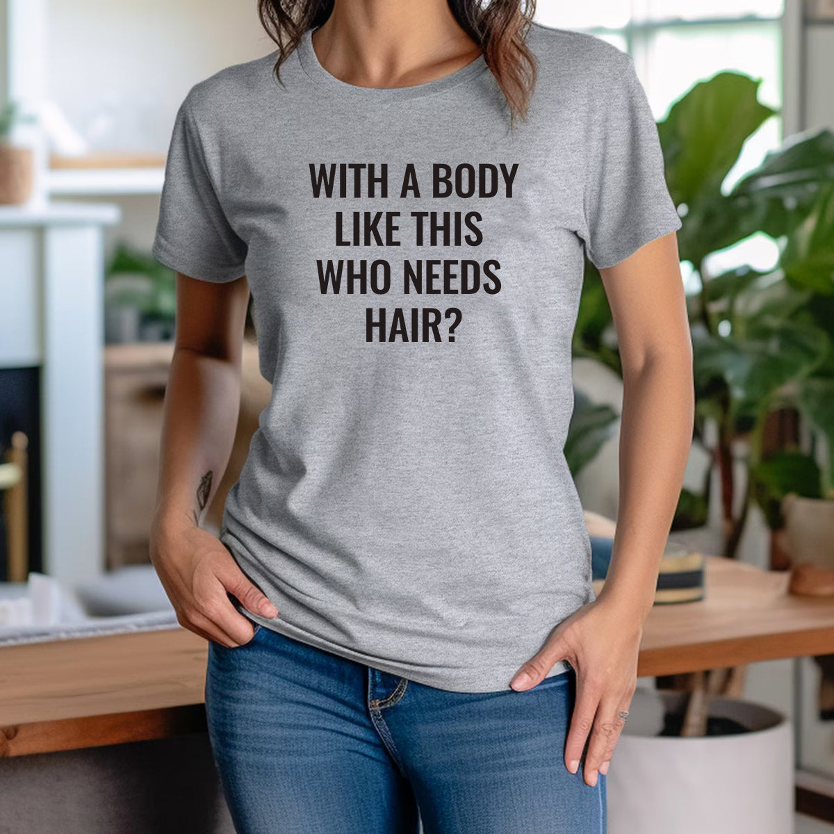 Woman wearing a grey funny slogan t-shirt that says "With a body like this who needs hair?" casual outfit style.