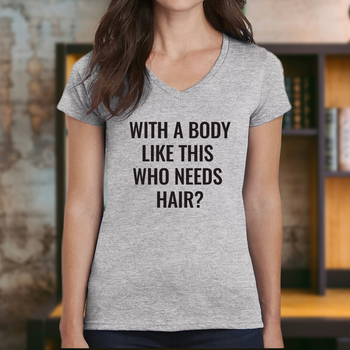 Women’s v-neck grey t-shirt with printed joke text "With a body like this who needs hair?" – novelty tee.