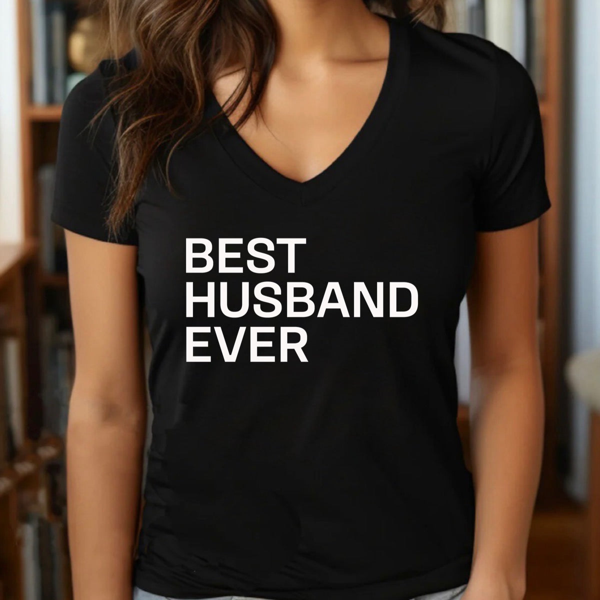 Woman wearing black v-neck t-shirt with bold white Best Husband Ever lettering