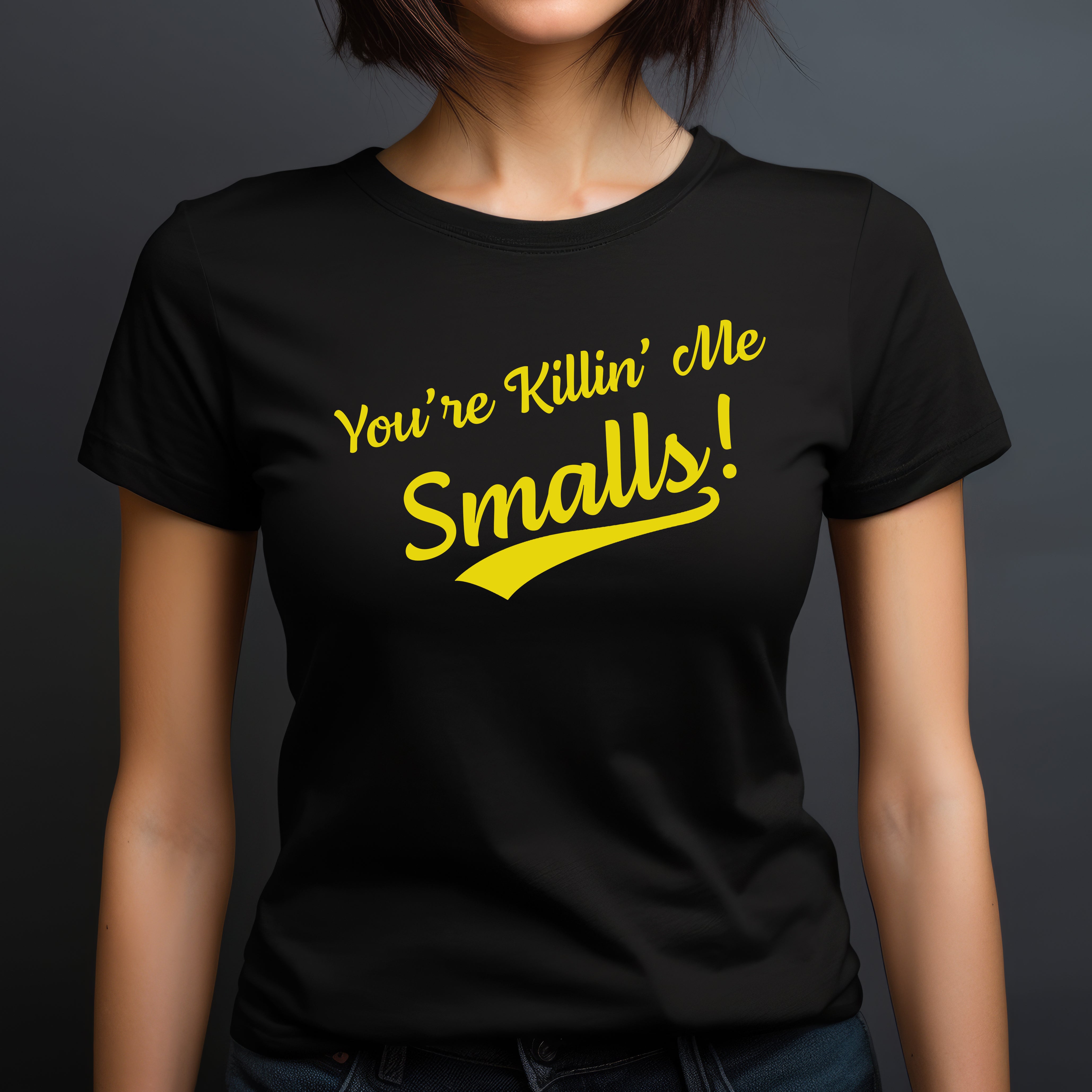Woman in black crew neck shirt featuring yellow You're Killin' Me Smalls funny quote design