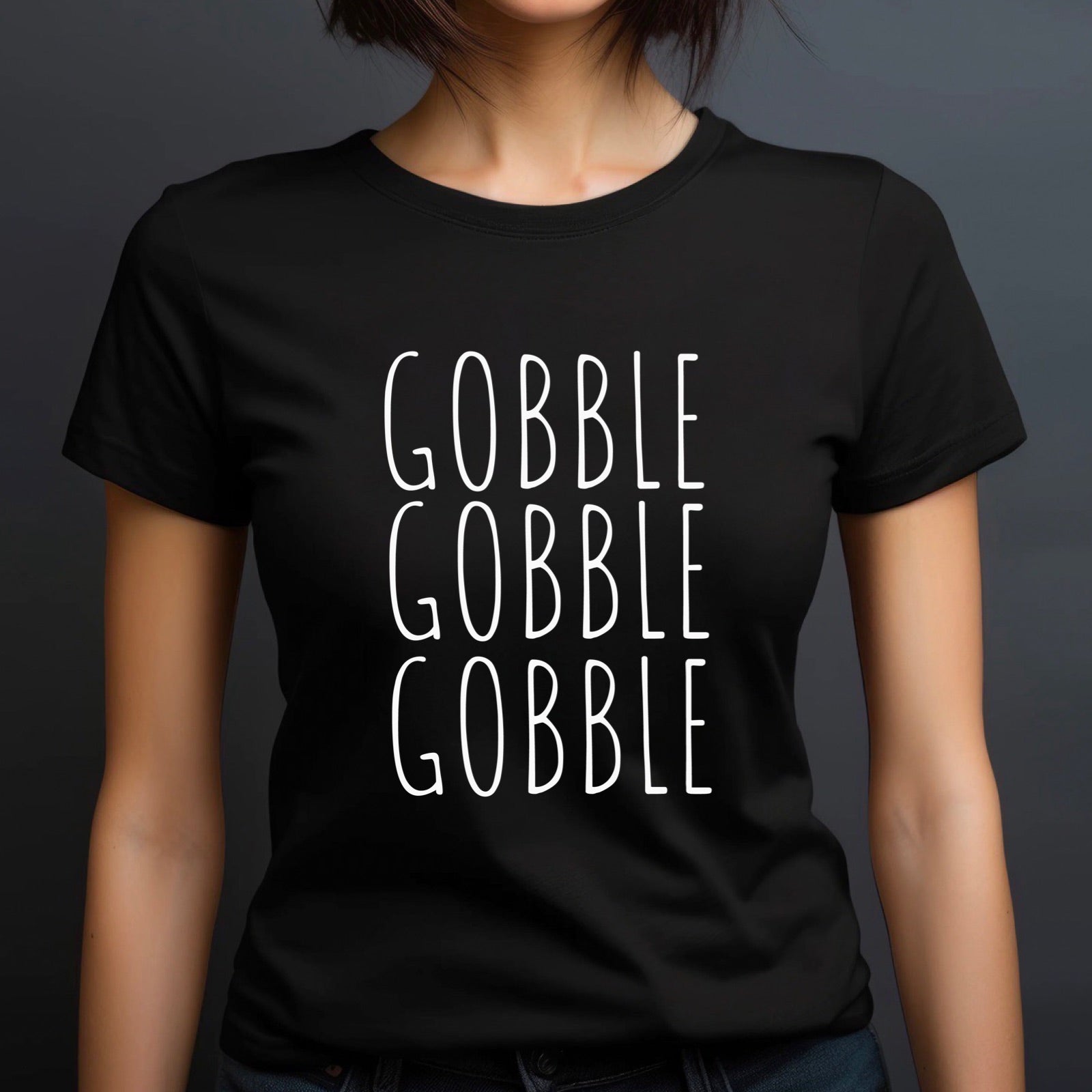 Woman in crew neck black t-shirt with Gobble Gobble Gobble holiday design