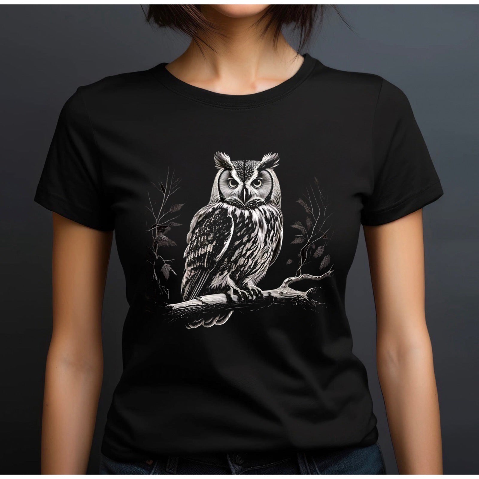 Women’s black crewneck t-shirt featuring owl on branch woodland design on dark backdrop