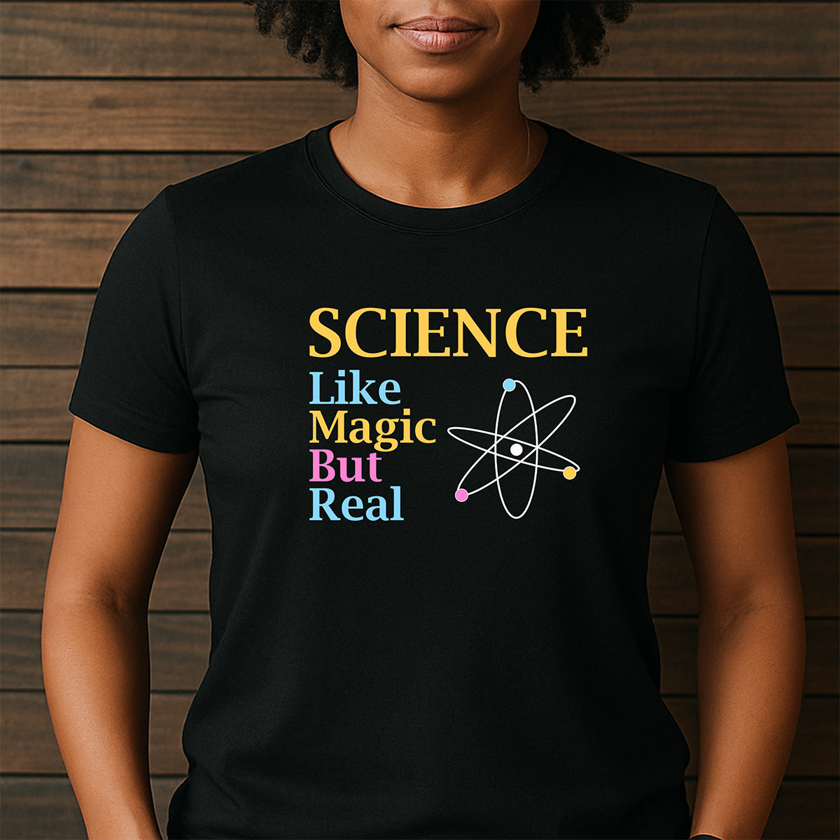 Woman in black crewneck Science Like Magic But Real atom graphic T-shirt, casual everyday science tee
