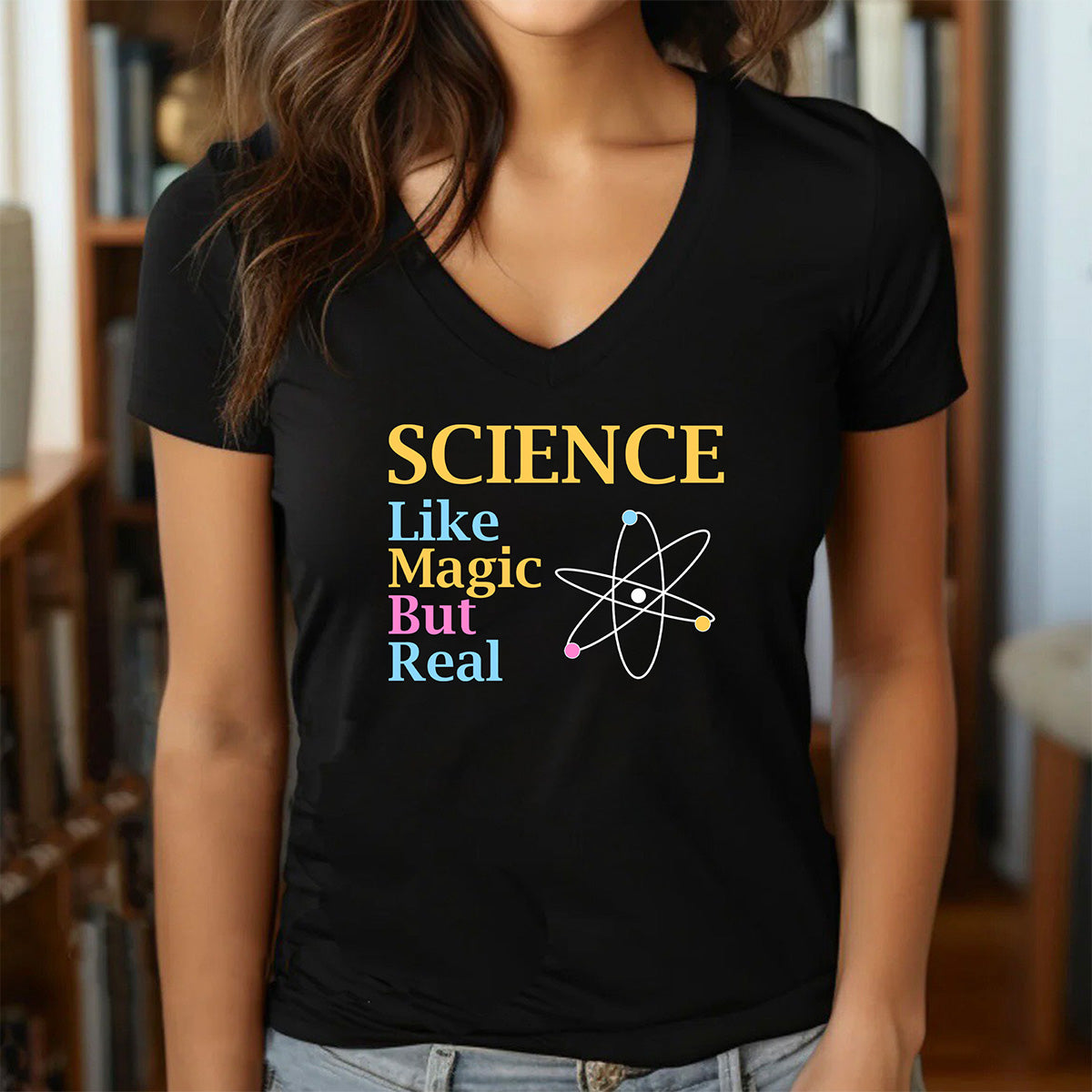 Woman in black V-neck Science Like Magic But Real shirt with atom graphic, fitted geeky gift tee