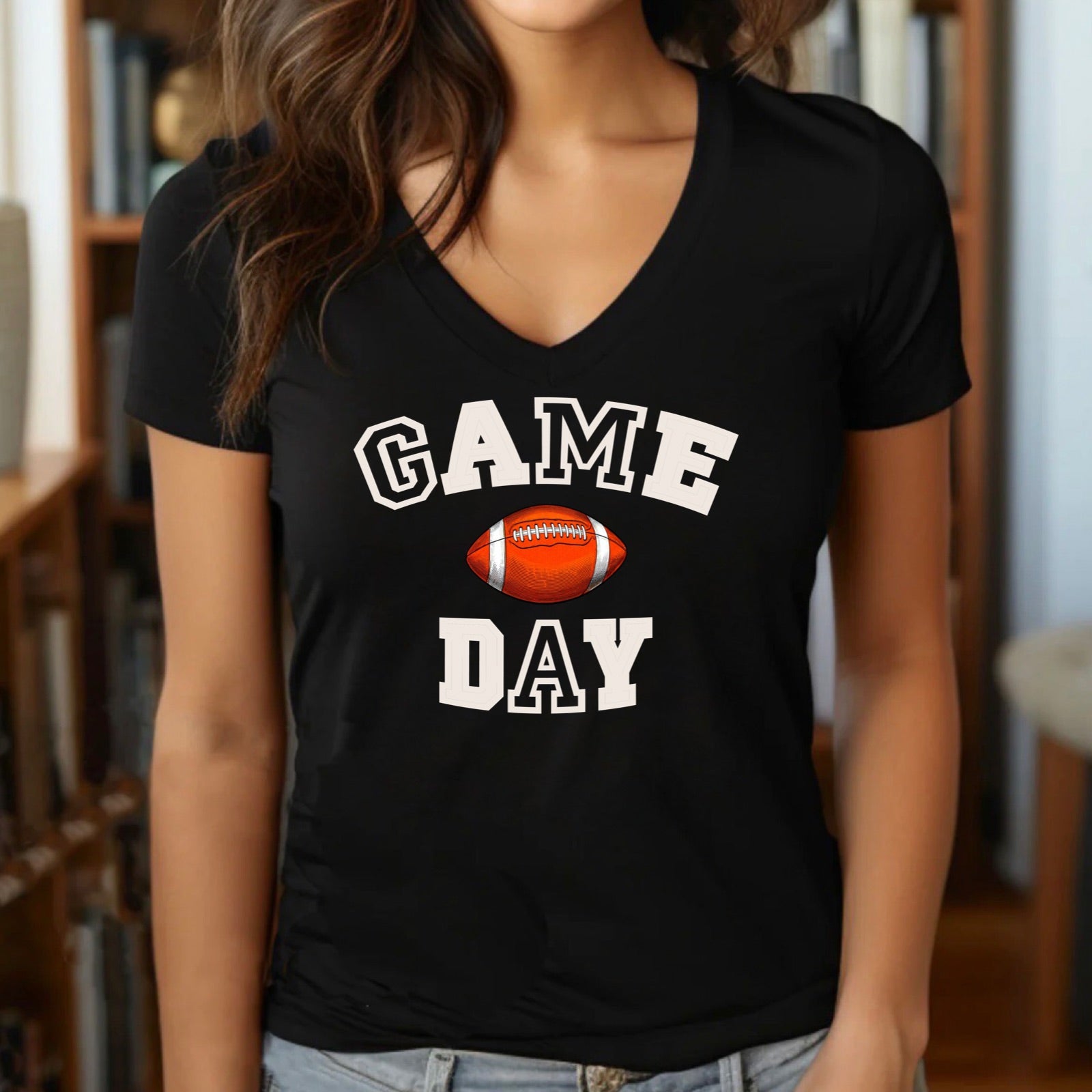 Woman in v-neck black t-shirt with bold Game Day football graphic