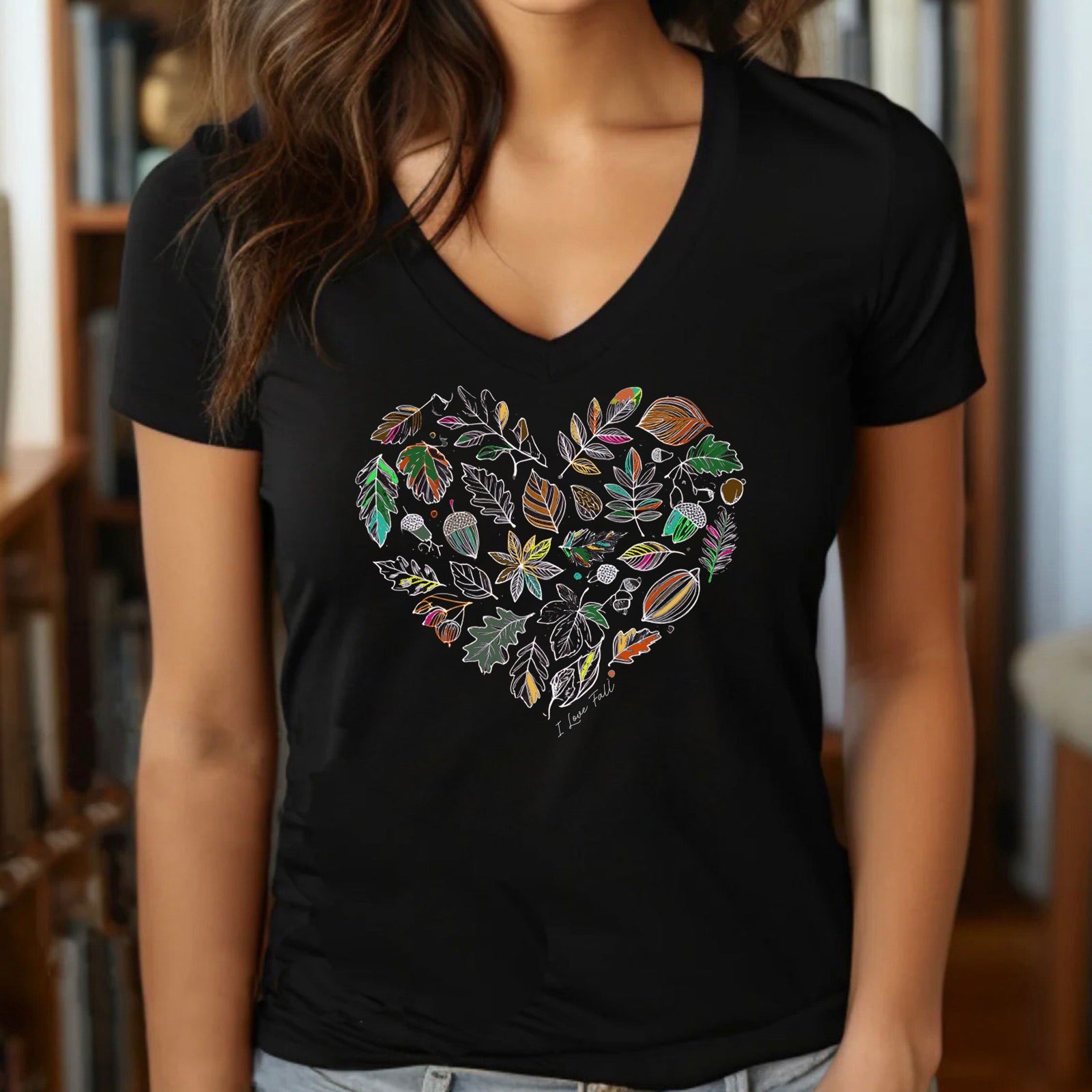 Woman in v-neck black t-shirt with heart-shaped fall leaf design and autumn theme